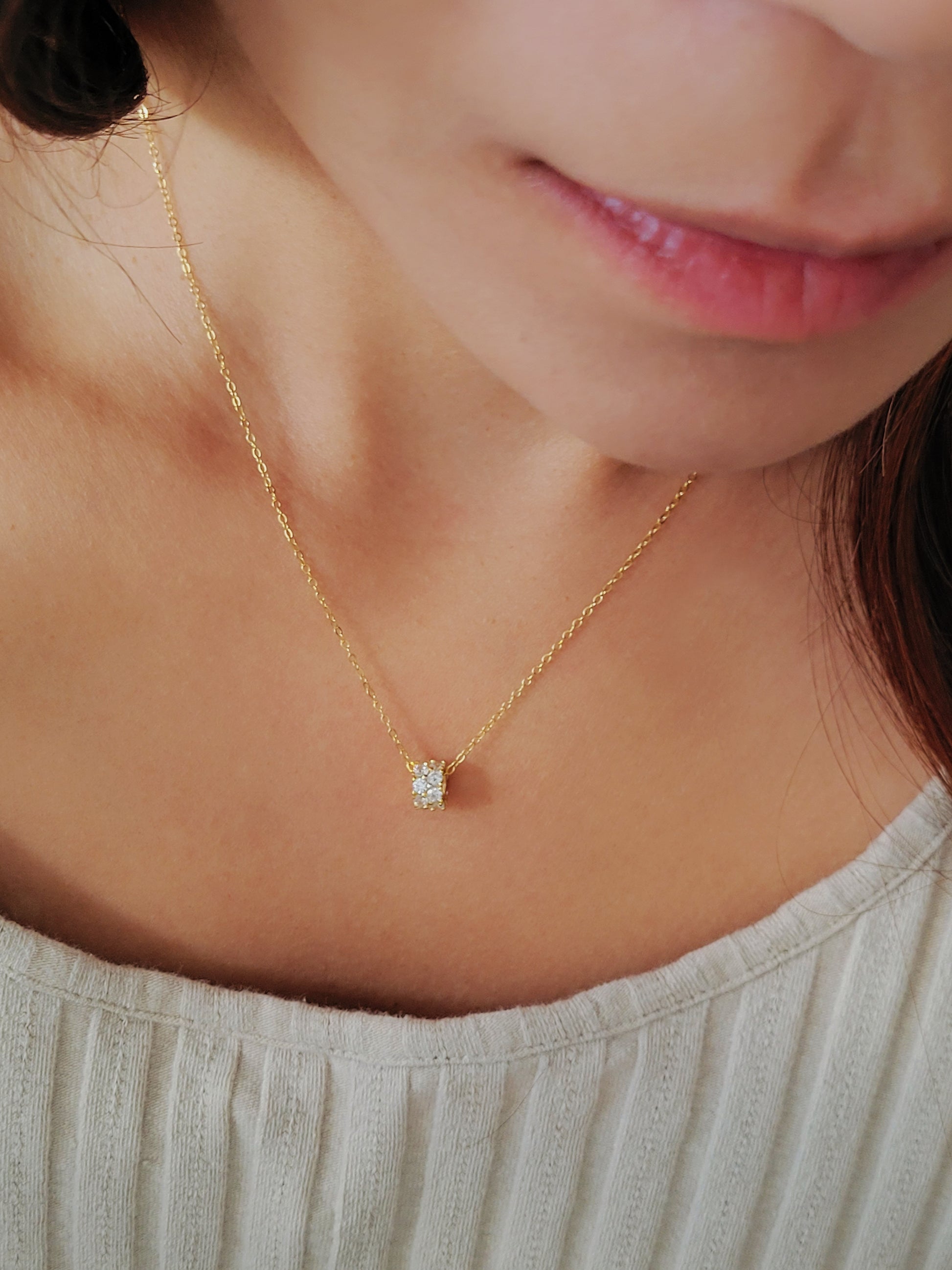Luxurious close-up of a gold round shaped barrel necklace featuring sparkling pave zircons.