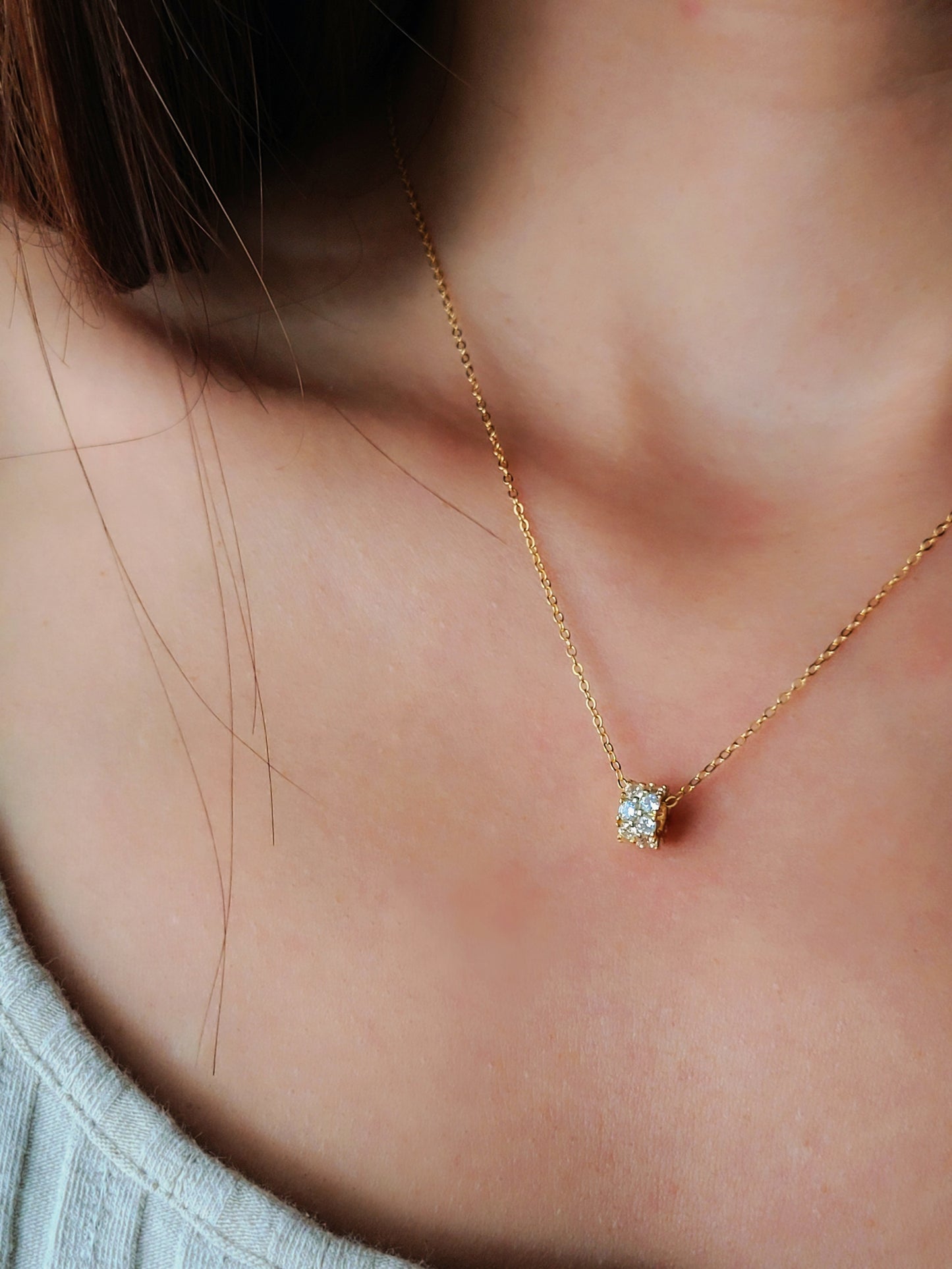 Luxurious close-up of a gold round shaped barrel necklace featuring sparkling pave zircons.