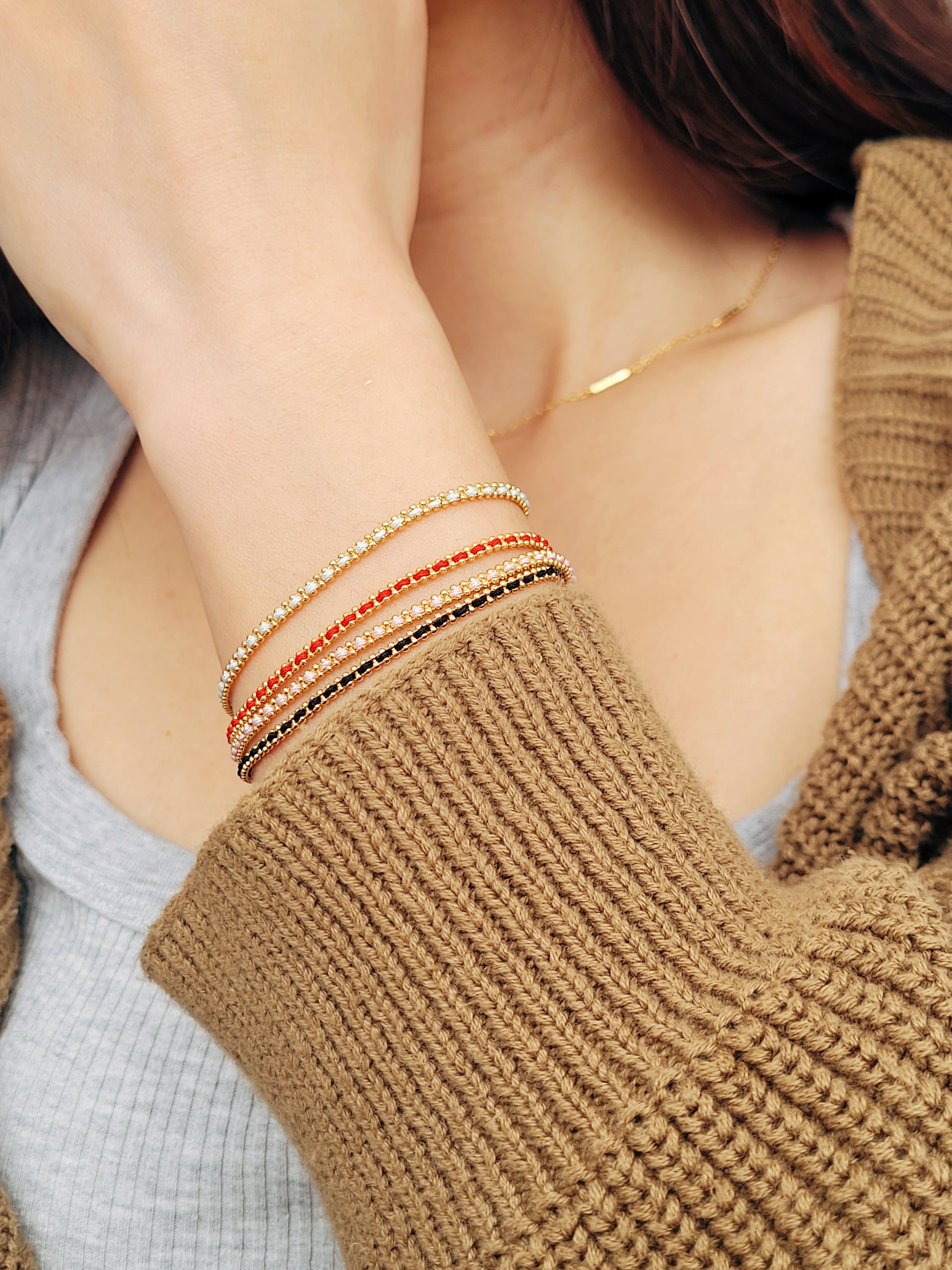 Gold-plated sterling silver string bracelets in Black, Blue, Red and Pink, perfect as friendship bracelets or meaningful graduation gifts for everyday wear.