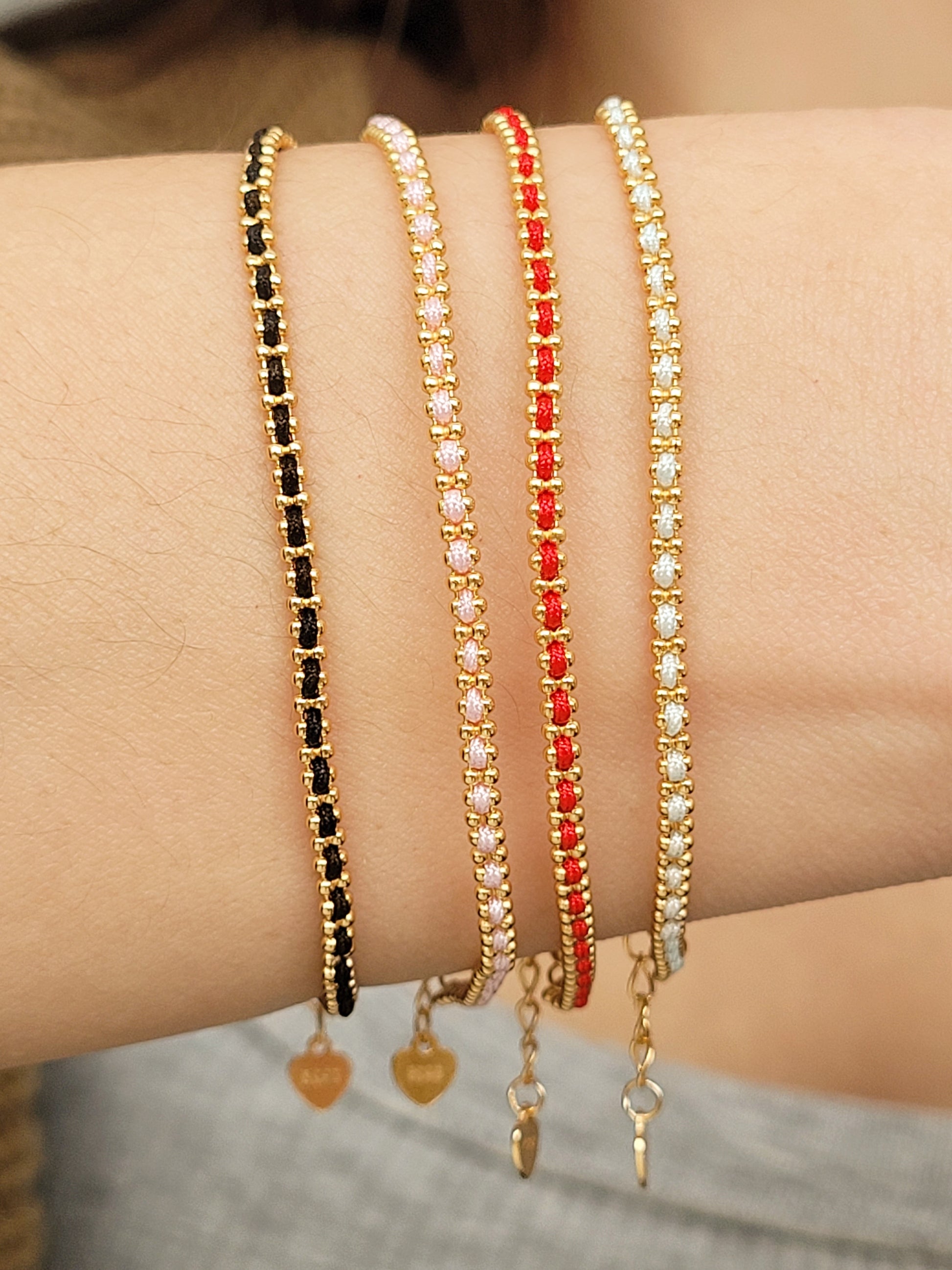 Gold-plated sterling silver string bracelets in Black, Blue, Red and Pink, perfect as friendship bracelets or meaningful graduation gifts for everyday wear.