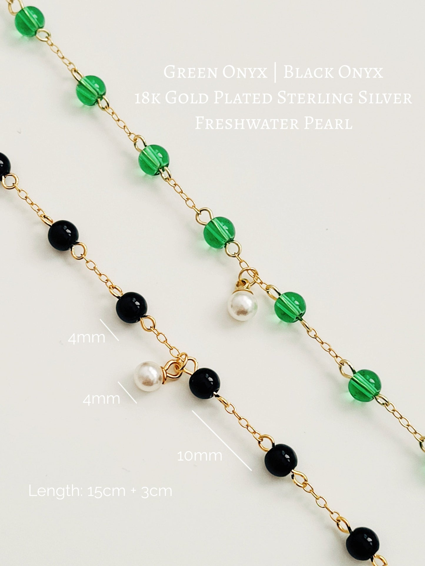 Elegant gold chain bracelet with green gemstone beads and a dainty pearl drop, perfect for a minimalist look.