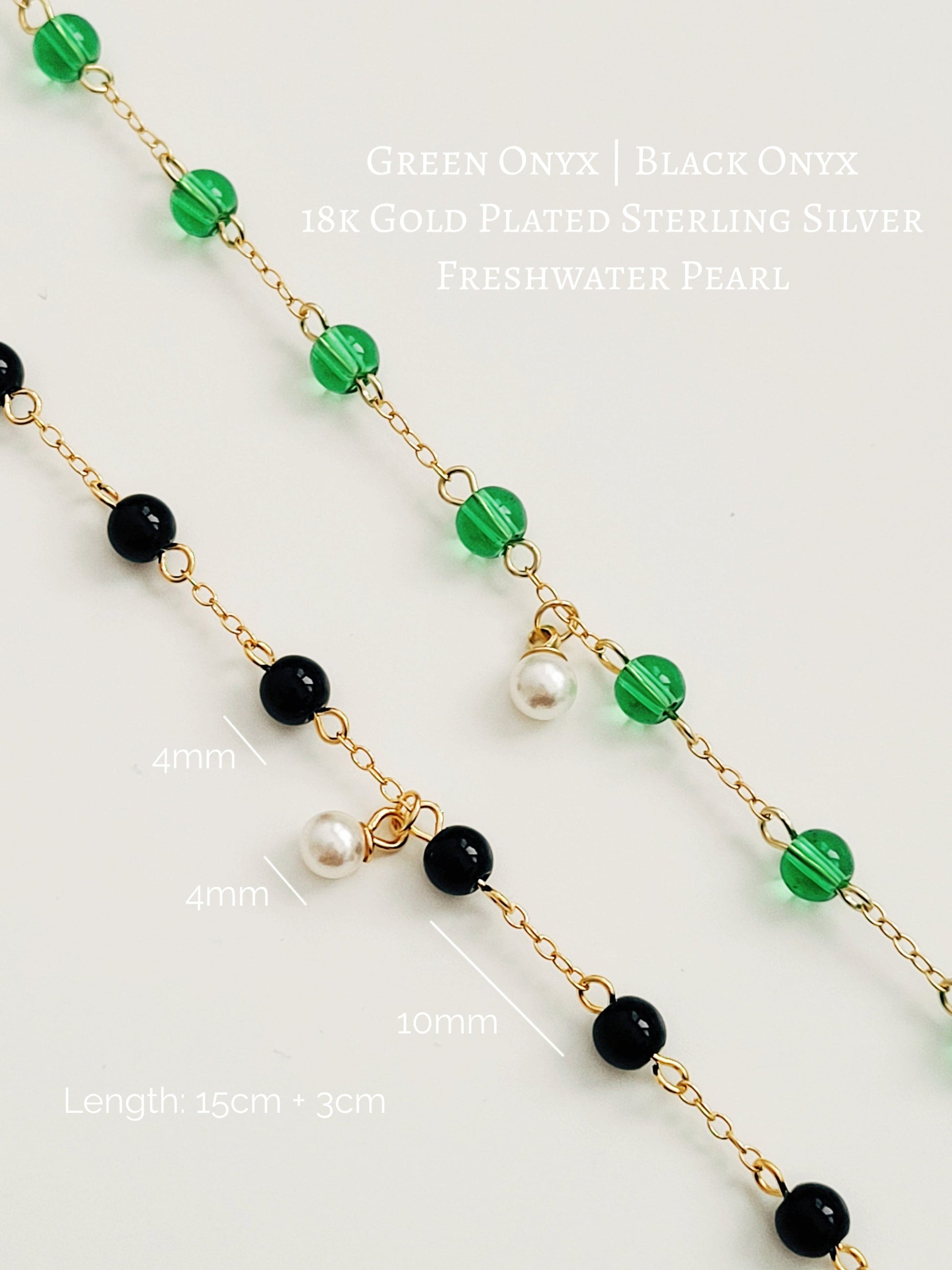 Elegant gold chain bracelet with green gemstone beads and a dainty pearl drop, perfect for a minimalist look.