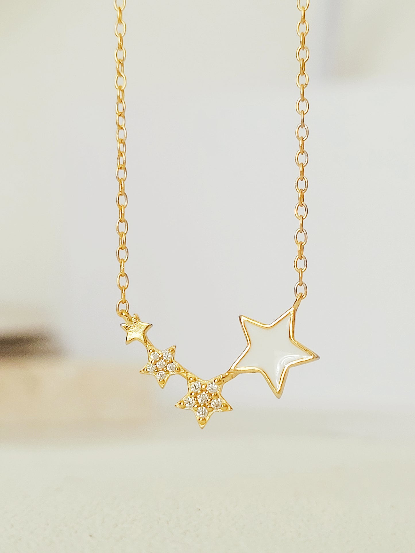 Close-up of the Stars Pendant Necklace showcasing the detailed craftmanship.