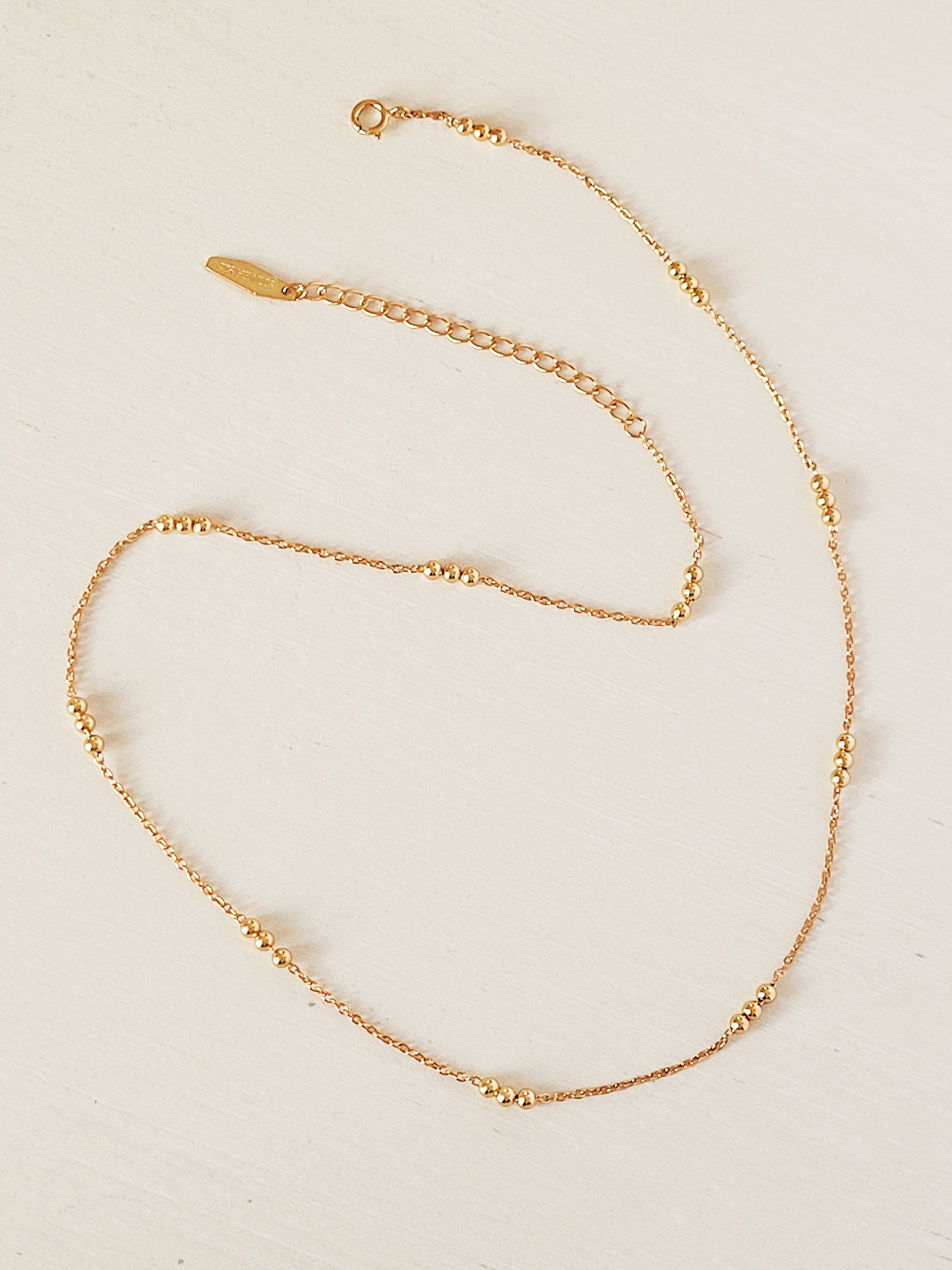 Elegant 18ct gold vermeil Triple Ball Necklace, crafted with a delicate gold chain and three polished beads. The rich gold hue of the vermeil finish provides a luxurious yet versatile piece.
