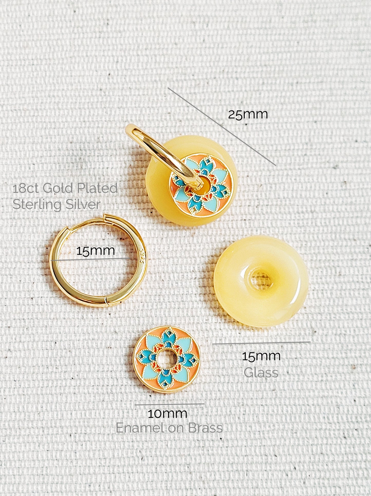 Close-up of vintage tile-pattern-inspired gold hoop earrings with floral detailing, displayed on a white background.