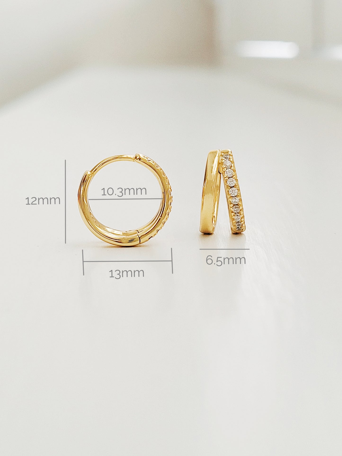 Stylish gold double hoop earrings with a sleek design, perfect for adding a touch of elegance to any outfit.