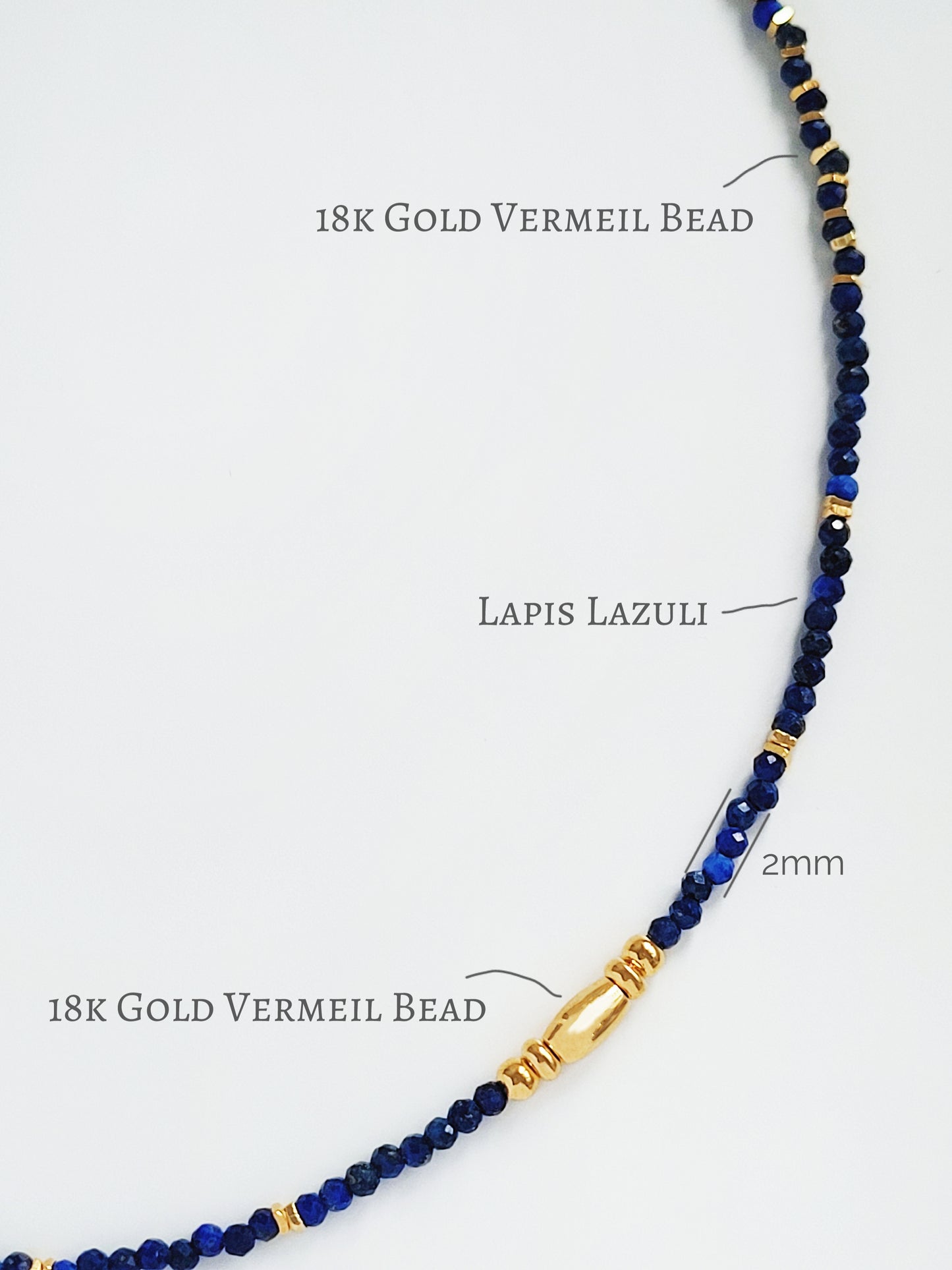 A delicate Lapis Lazuli beaded necklace featuring deep blue 2mm faceted gemstones and accented with 18k gold vermeil beads, styled as a minimalist choker necklace, perfect for gifting on birthdays, anniversaries, or special occasions.