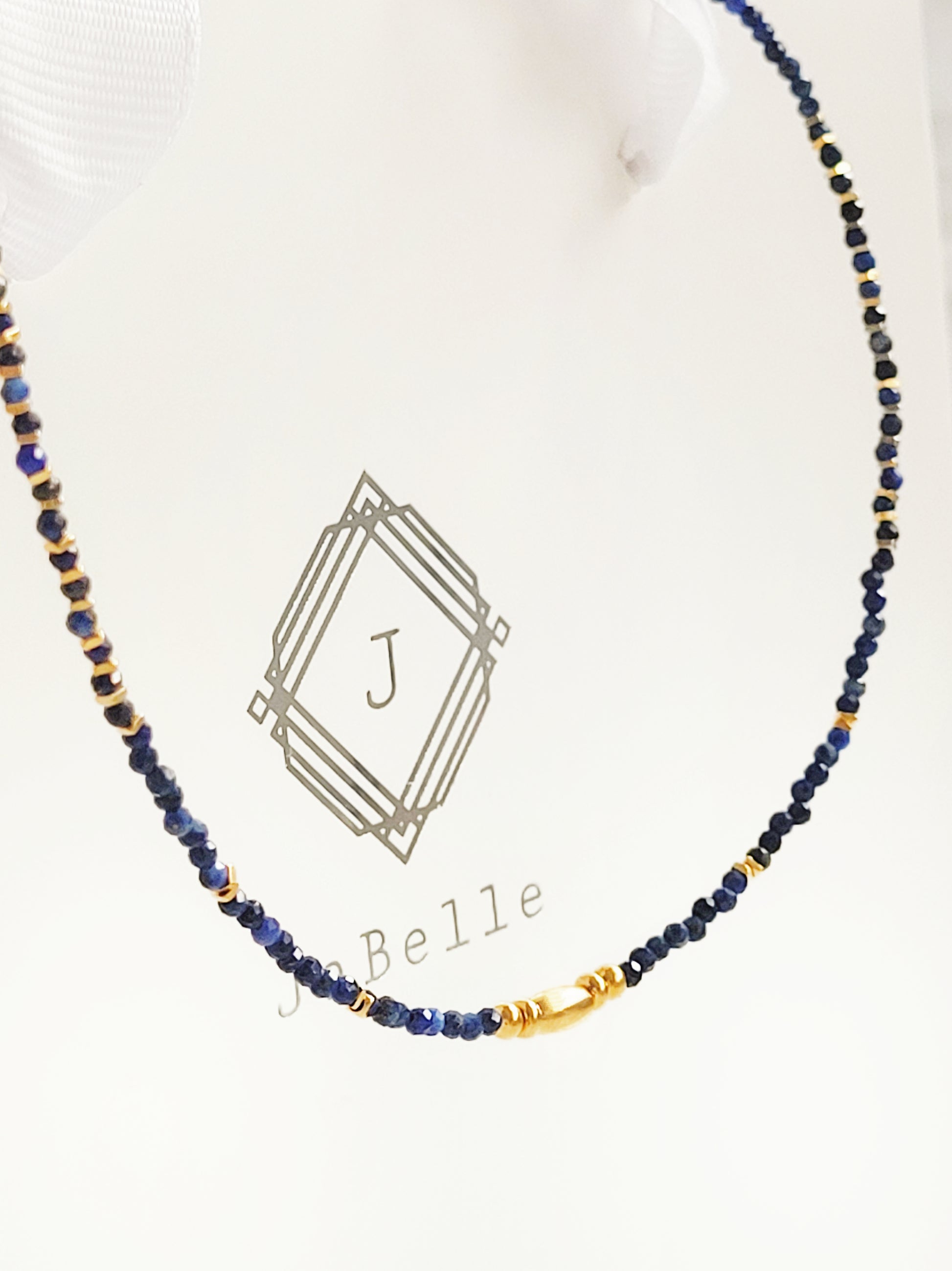A delicate Lapis Lazuli beaded necklace featuring deep blue 2mm faceted gemstones and accented with 18k gold vermeil beads, styled as a minimalist choker necklace, perfect for gifting on birthdays, anniversaries, or special occasions.