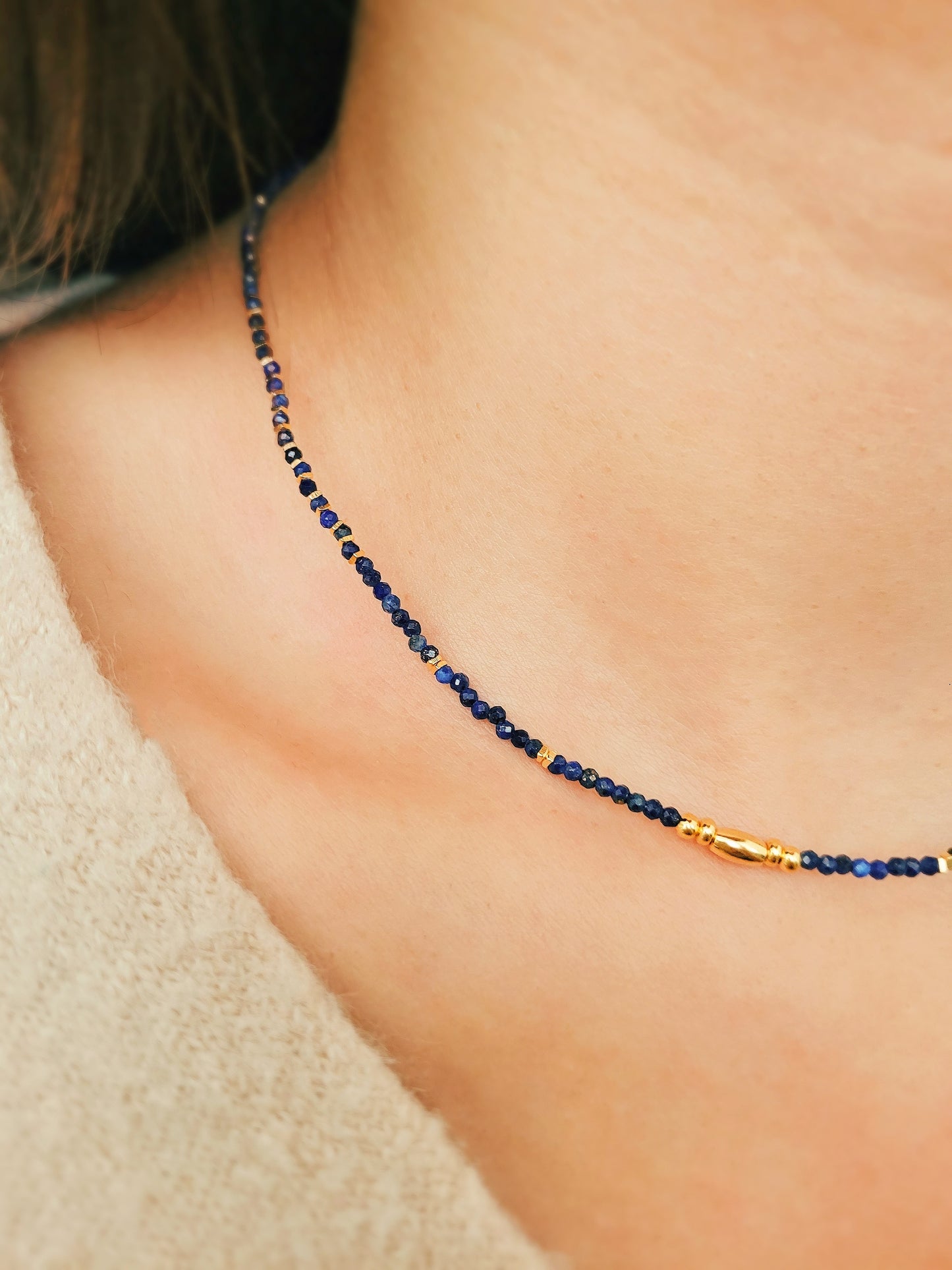 A delicate Lapis Lazuli beaded necklace featuring deep blue 2mm faceted gemstones and accented with 18k gold vermeil beads, styled as a minimalist choker necklace, perfect for gifting on birthdays, anniversaries, or special occasions.
