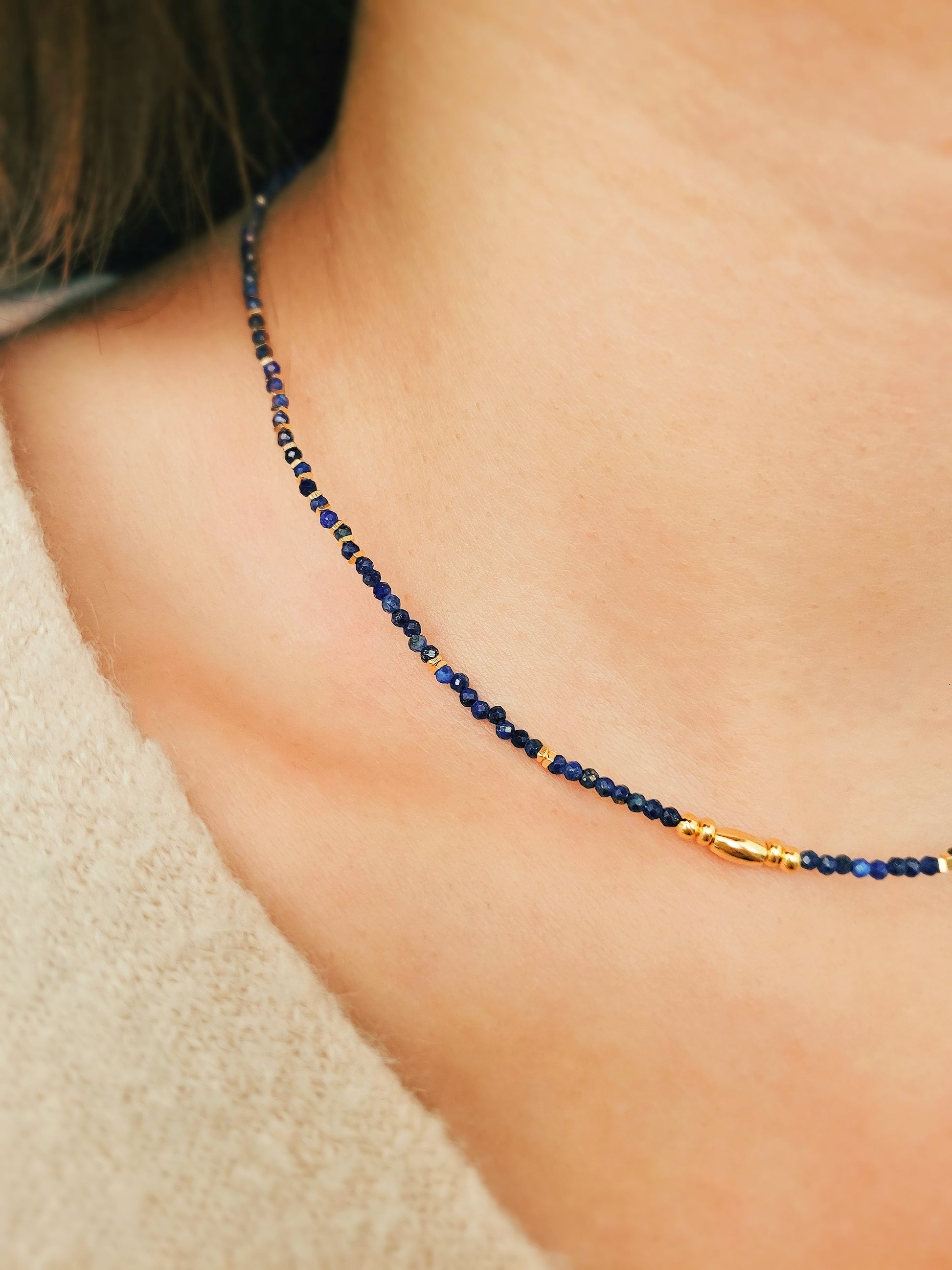 A delicate Lapis Lazuli beaded necklace featuring deep blue 2mm faceted gemstones and accented with 18k gold vermeil beads, styled as a minimalist choker necklace, perfect for gifting on birthdays, anniversaries, or special occasions.