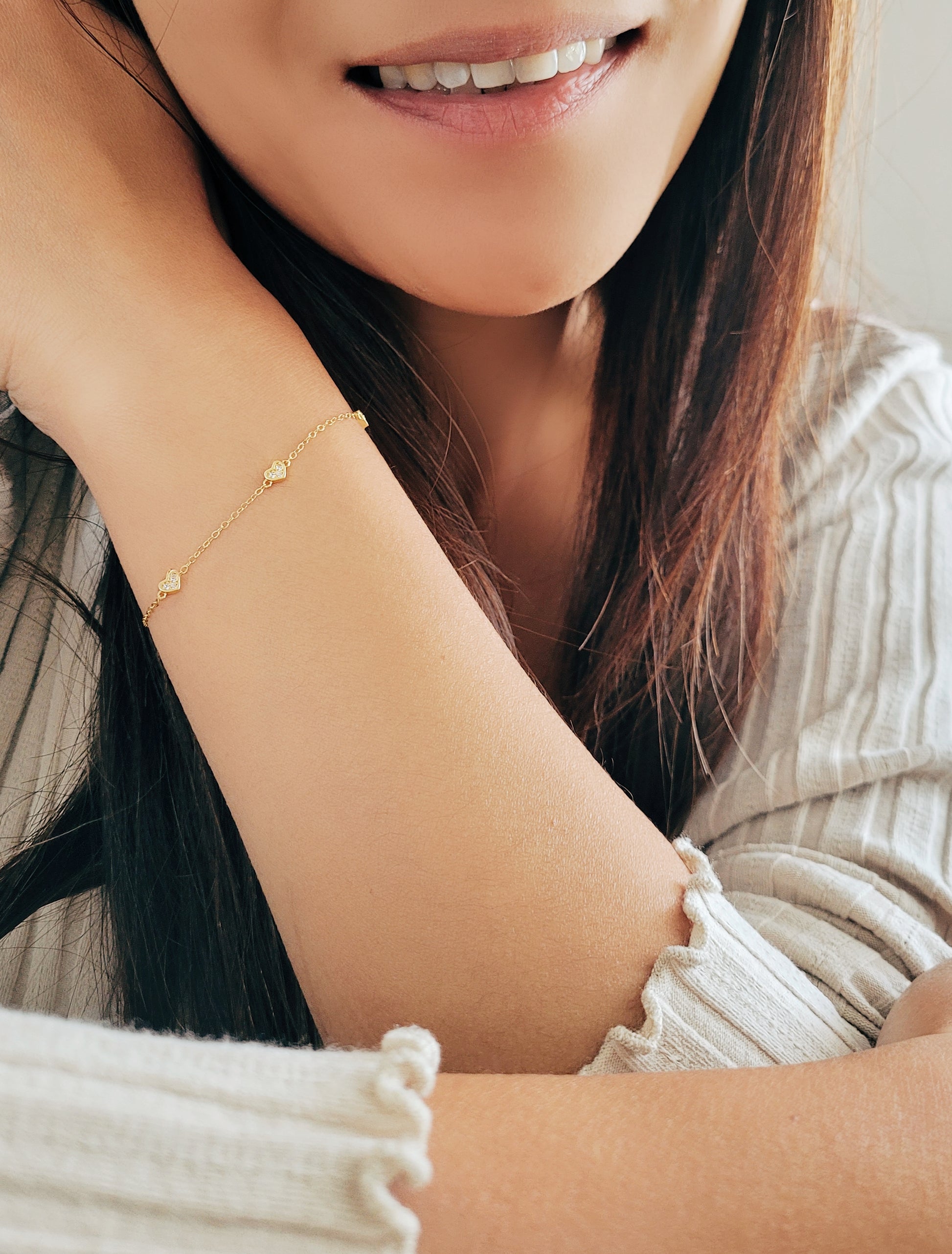 a woman feels so happy to wear the mini heart bracelet given by her best friend