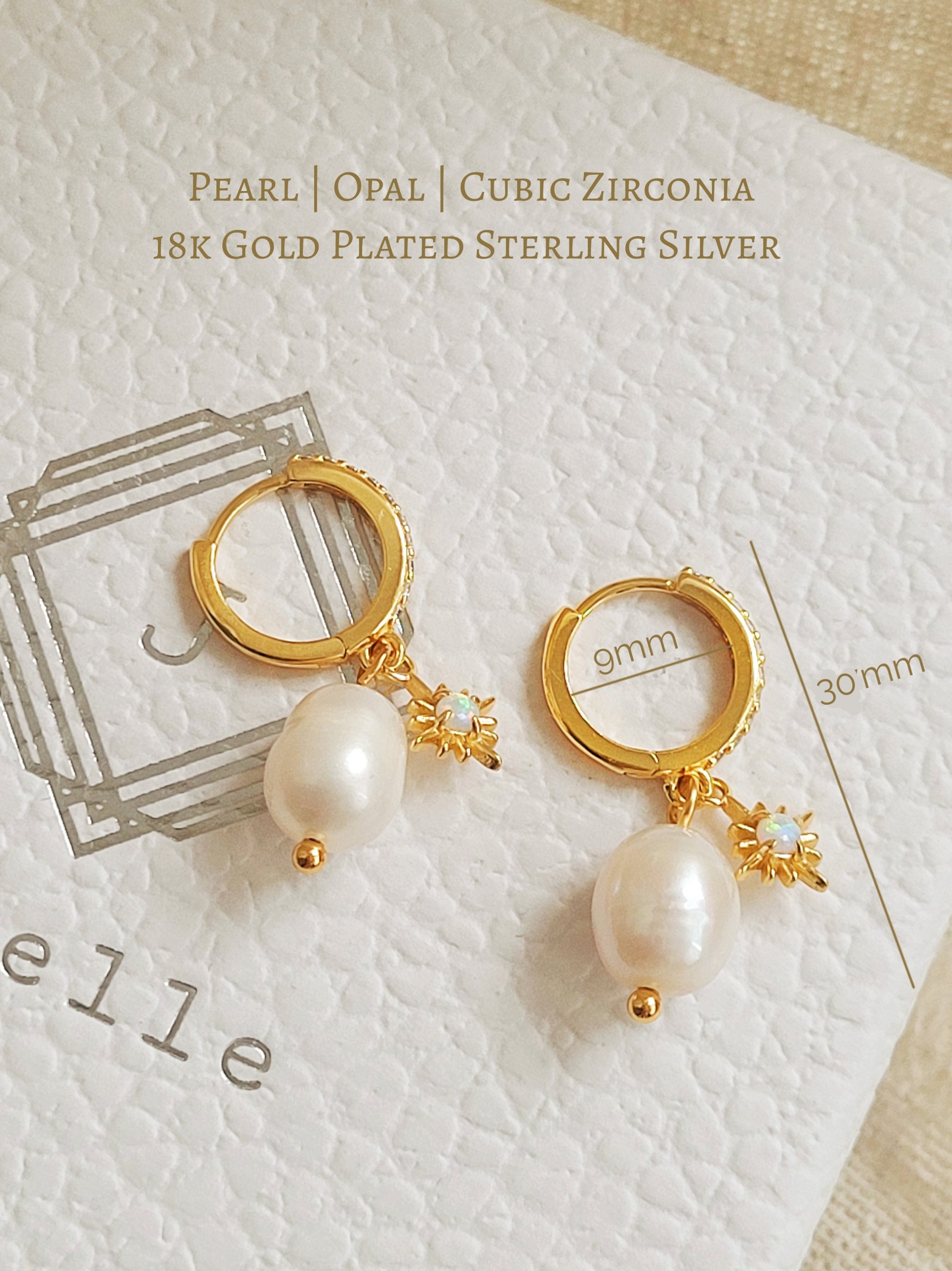 Dainty freshwater pearl drop huggie earring featuring a gold opal charm, crafted in gold plated sterling silver. Perfect bridal or everyday earrings with celestial charm and timeless sophistication. Birthday gift for her.