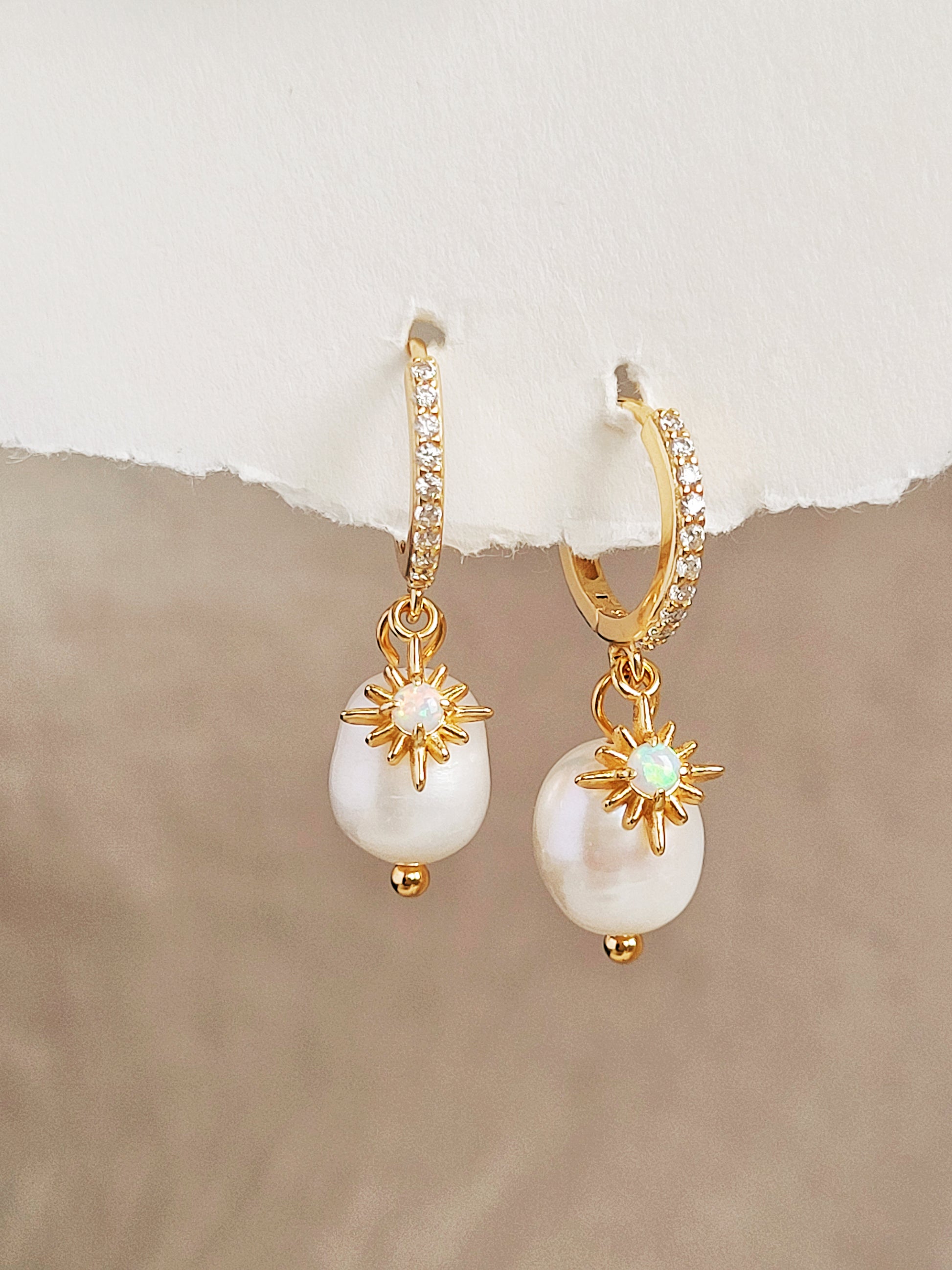 Elegant pearl drop earrings featuring a gold opal star charm, crafted in gold plated sterling silver. Perfect bridal or everyday earrings with celestial charm and timeless sophistication. Anniversary gift for her.