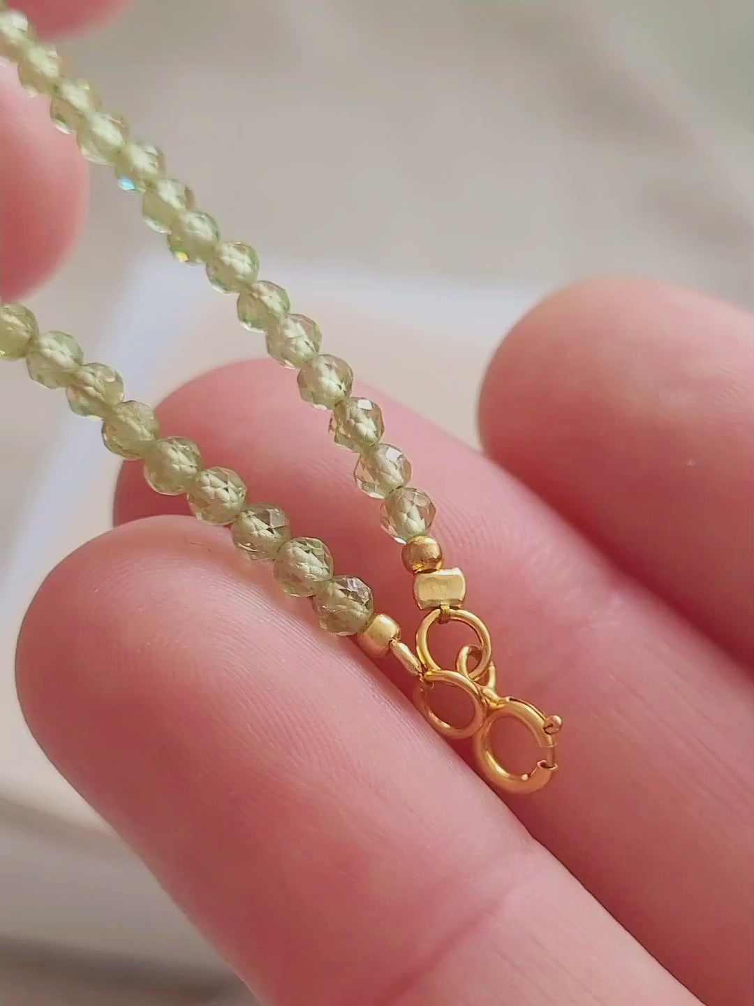 Minimalist peridot gemstone bracelet wearing on a woman hand