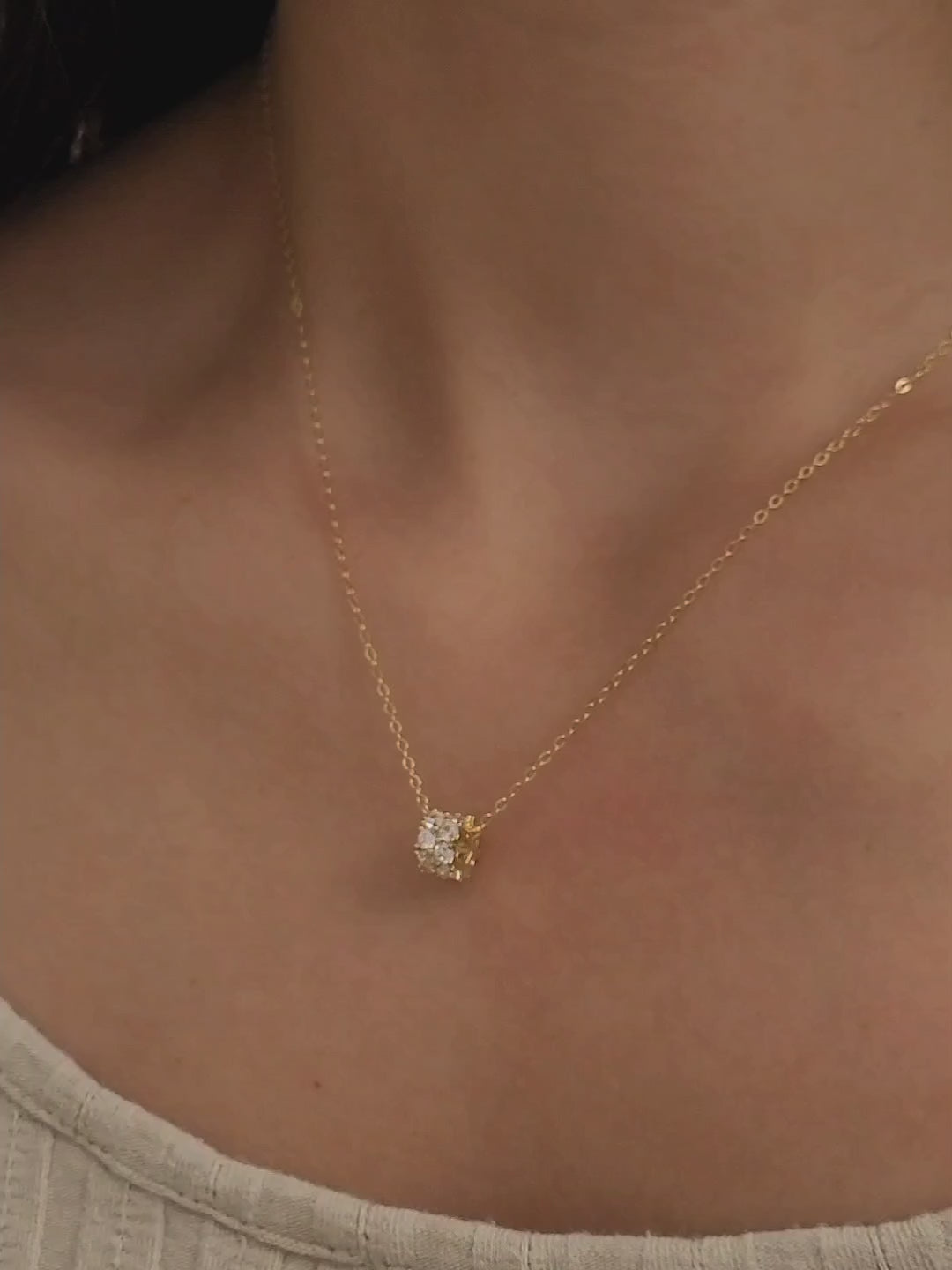 Luxurious close-up of a gold round shaped barrel necklace featuring sparkling pave zircons.