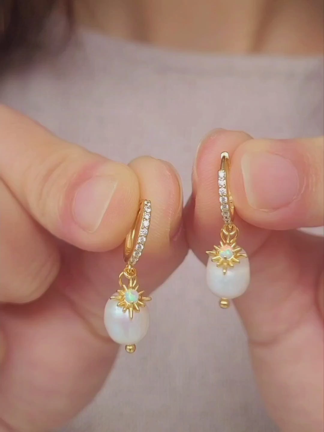 Woman wearing minimalist Opal huggie earrings featuring a freshwater pearl drop, crafted in gold plated sterling silver. Perfect bridal or everyday earrings with celestial charm and timeless sophistication. Birthday gift for her.
