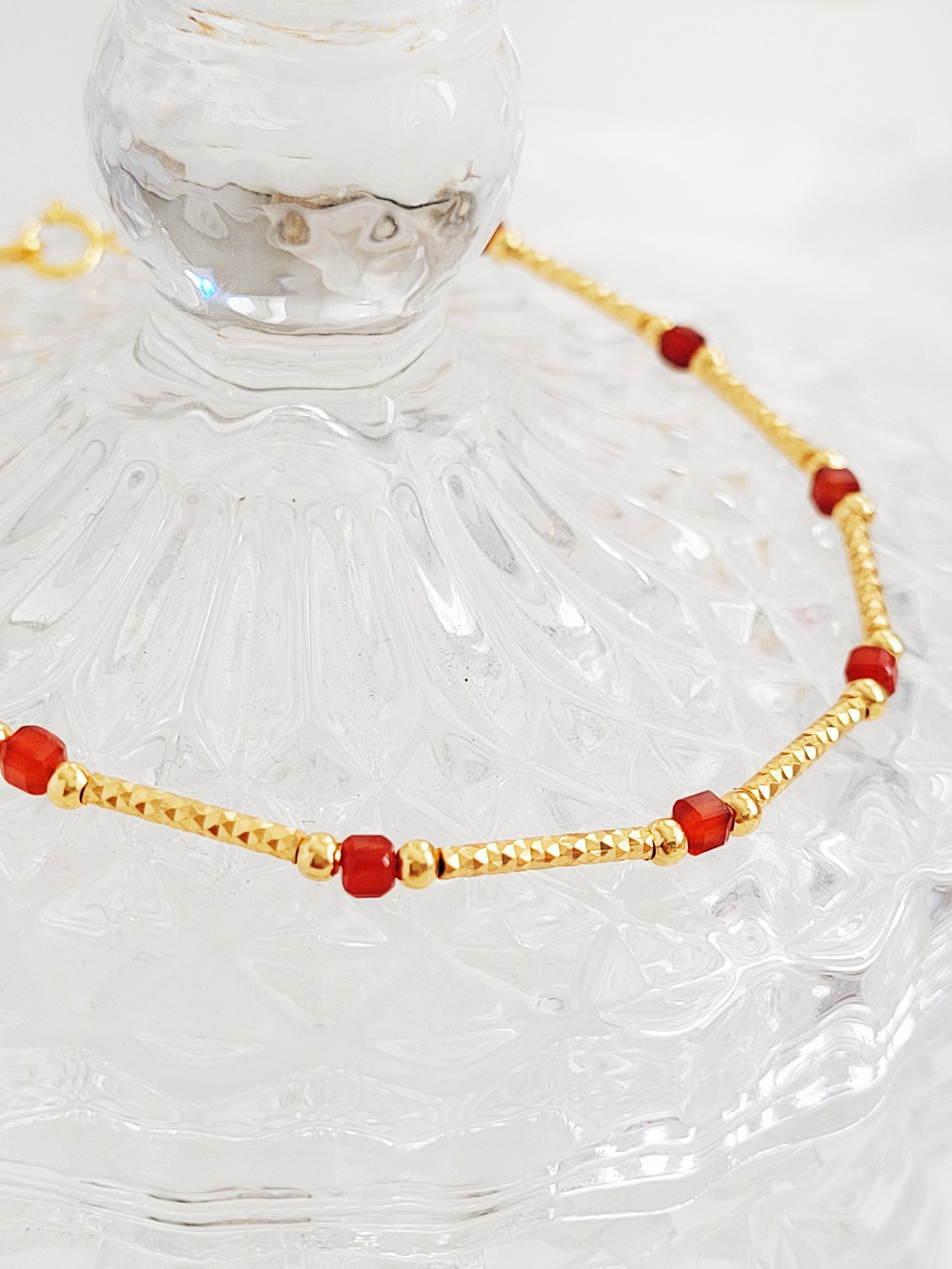 Close up of the red onyx gold bracelet details.
