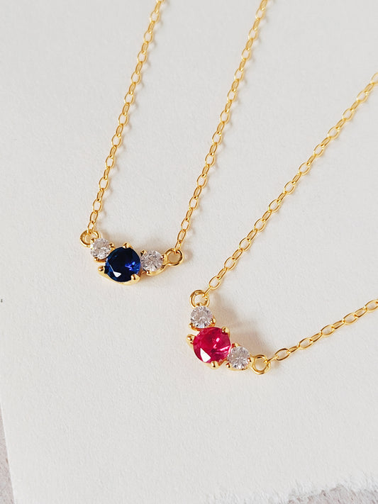 Delicate Angle Pendant Necklace with Blue and Red zirconia stones plated in 18k gold. Imitating the shape of angel, bringing protection to the one you love.
