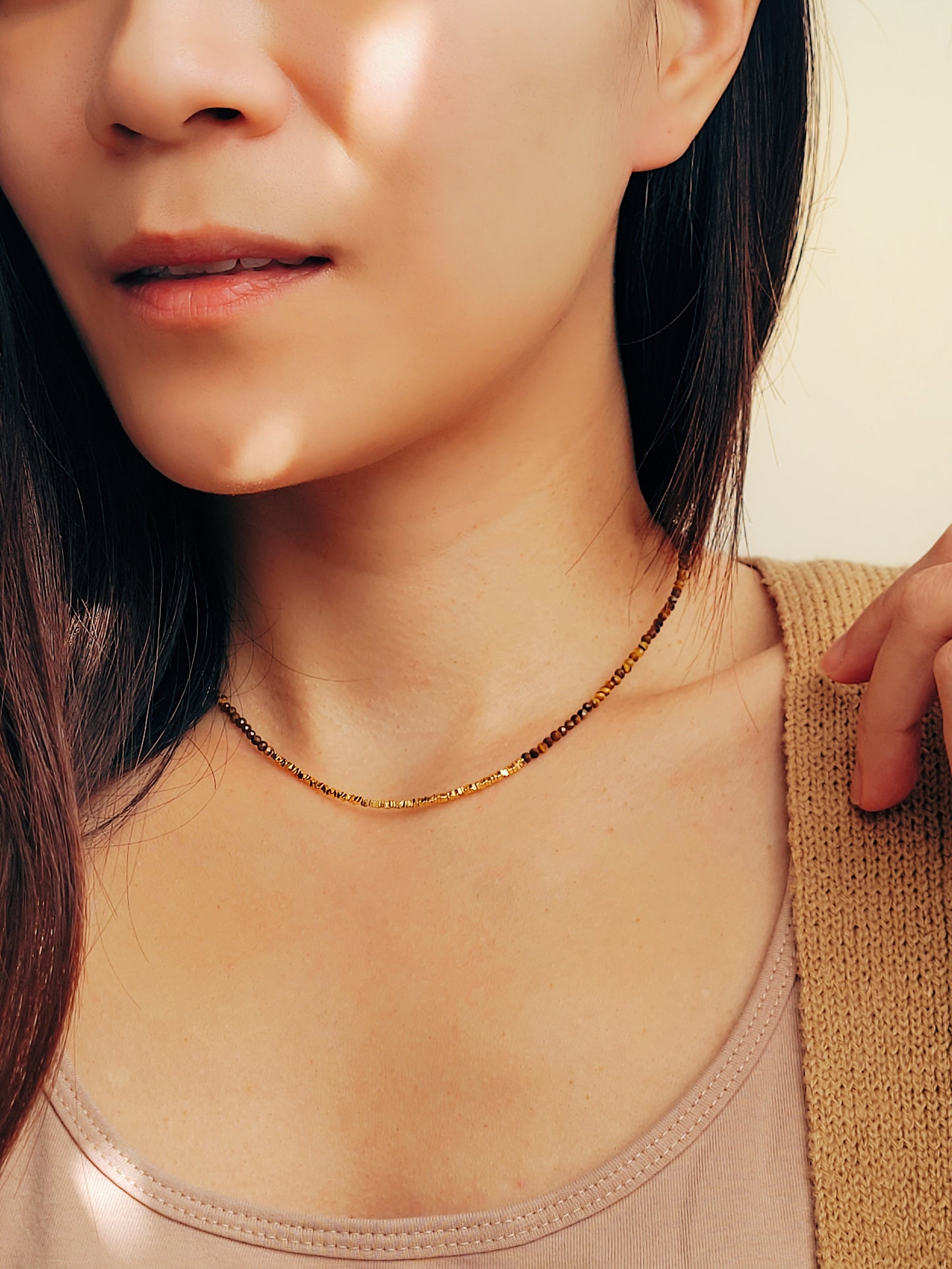 Close-up of woman wearing boho chic Tiger’s Eye gemstone choker necklace with 22K gold vermeil nugget beads in natural sunlight