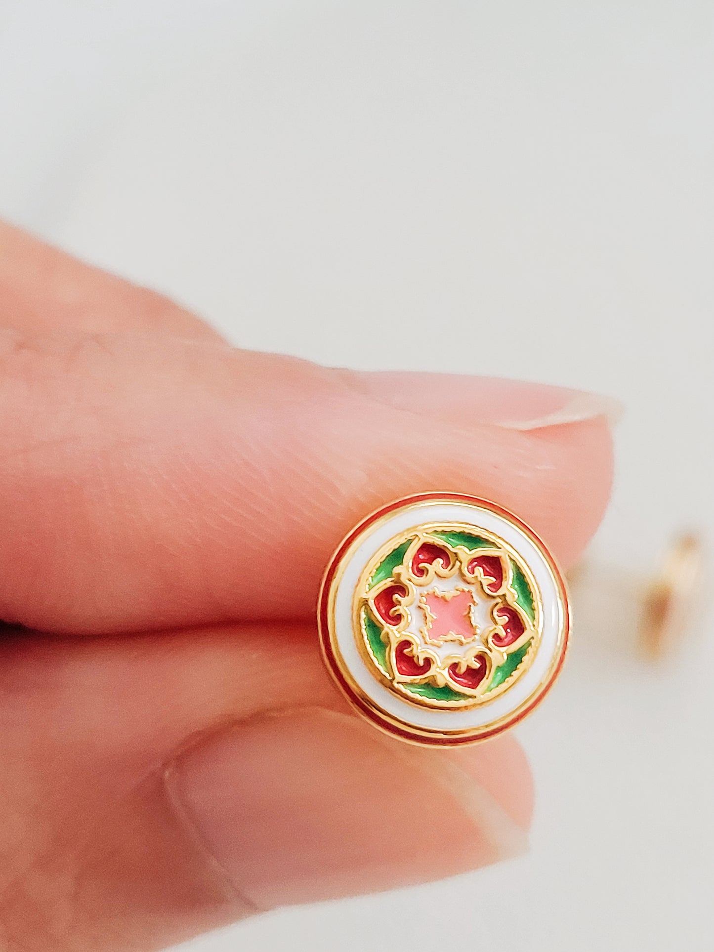 Gold-plated enamel stud earrings with vintage-inspired floral design in pink, green, and red, styled after classic Victorian ceramic tiles.