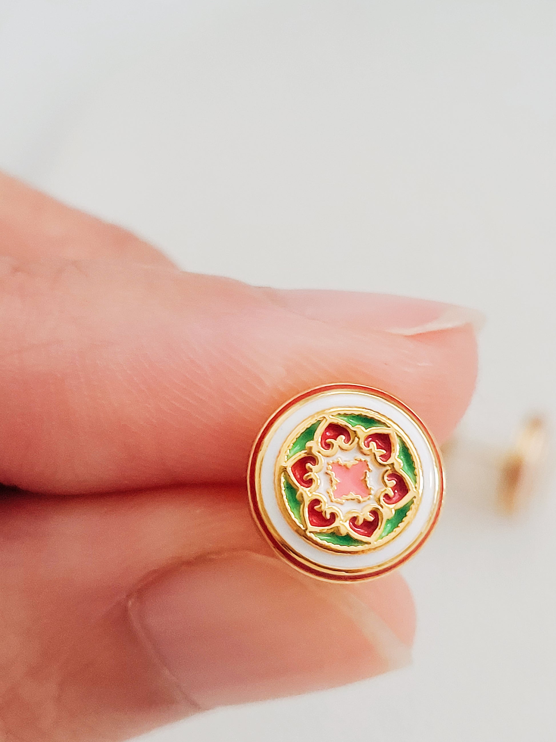Gold-plated enamel stud earrings with vintage-inspired floral design in pink, green, and red, styled after classic Victorian ceramic tiles.