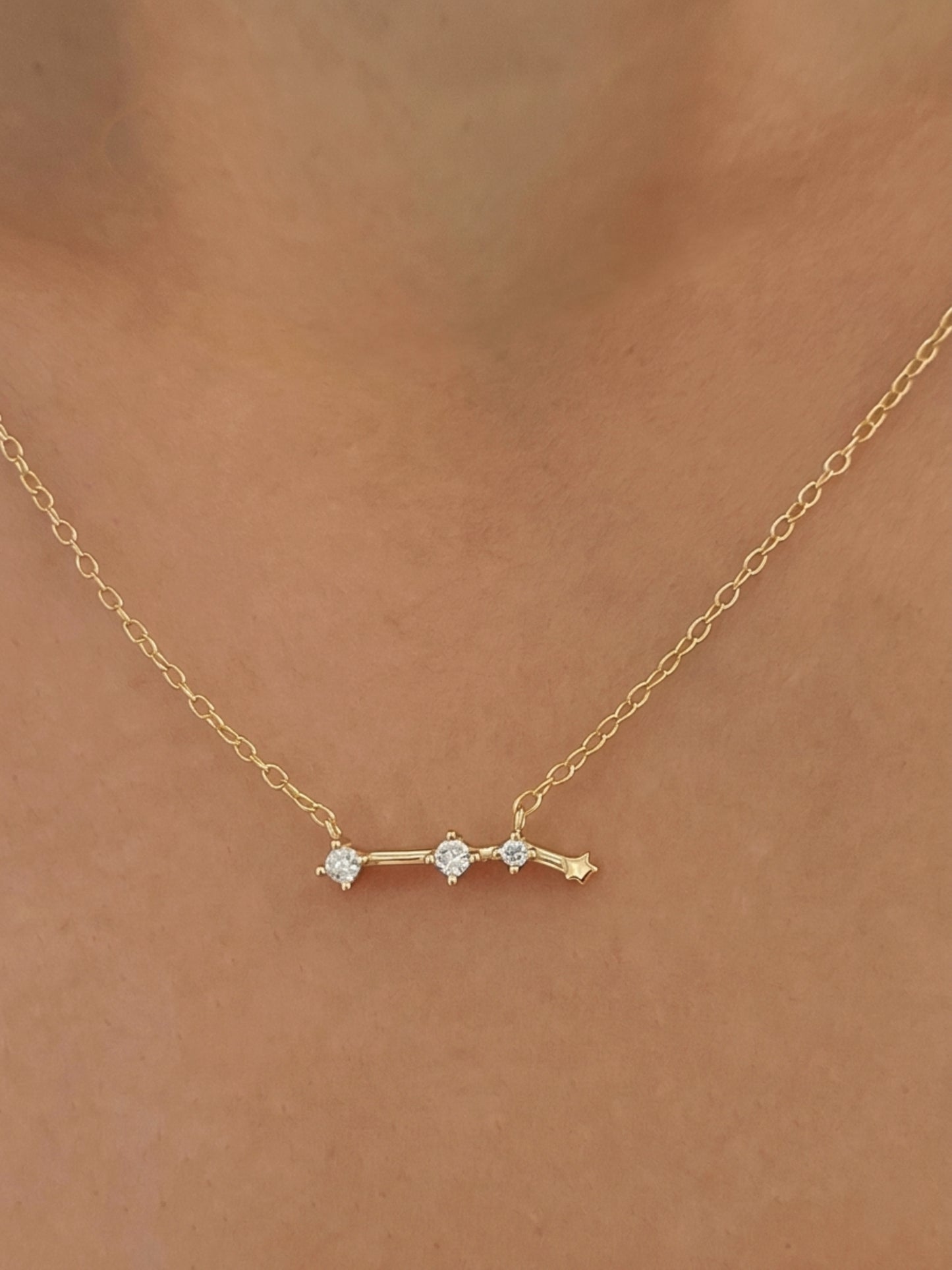 Close-up of a woman wearing an Aries necklace showcasing the luxury aesthetic and pendant scale. Crafted in gold vermeil, a perfect jewellery gift for her.