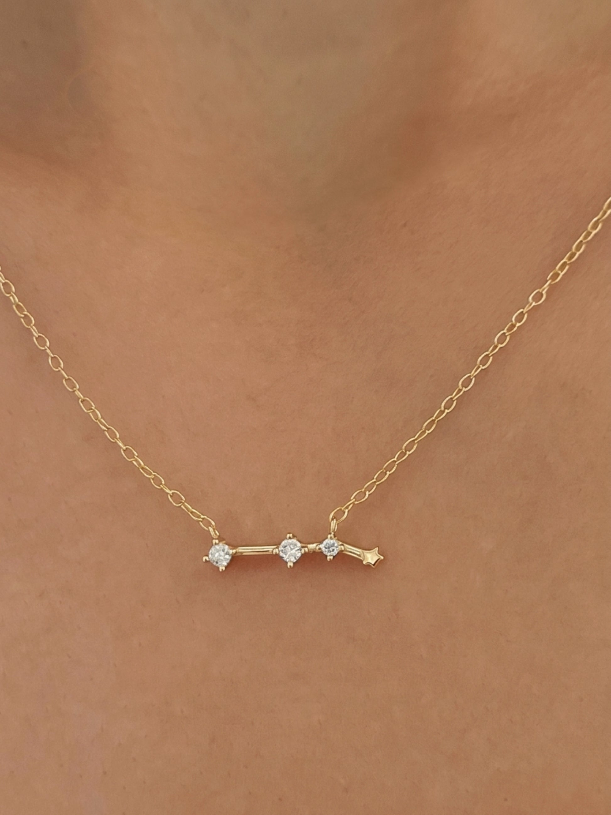 Close-up of a woman wearing an Aries necklace showcasing the luxury aesthetic and pendant scale. Crafted in gold vermeil, a perfect jewellery gift for her.