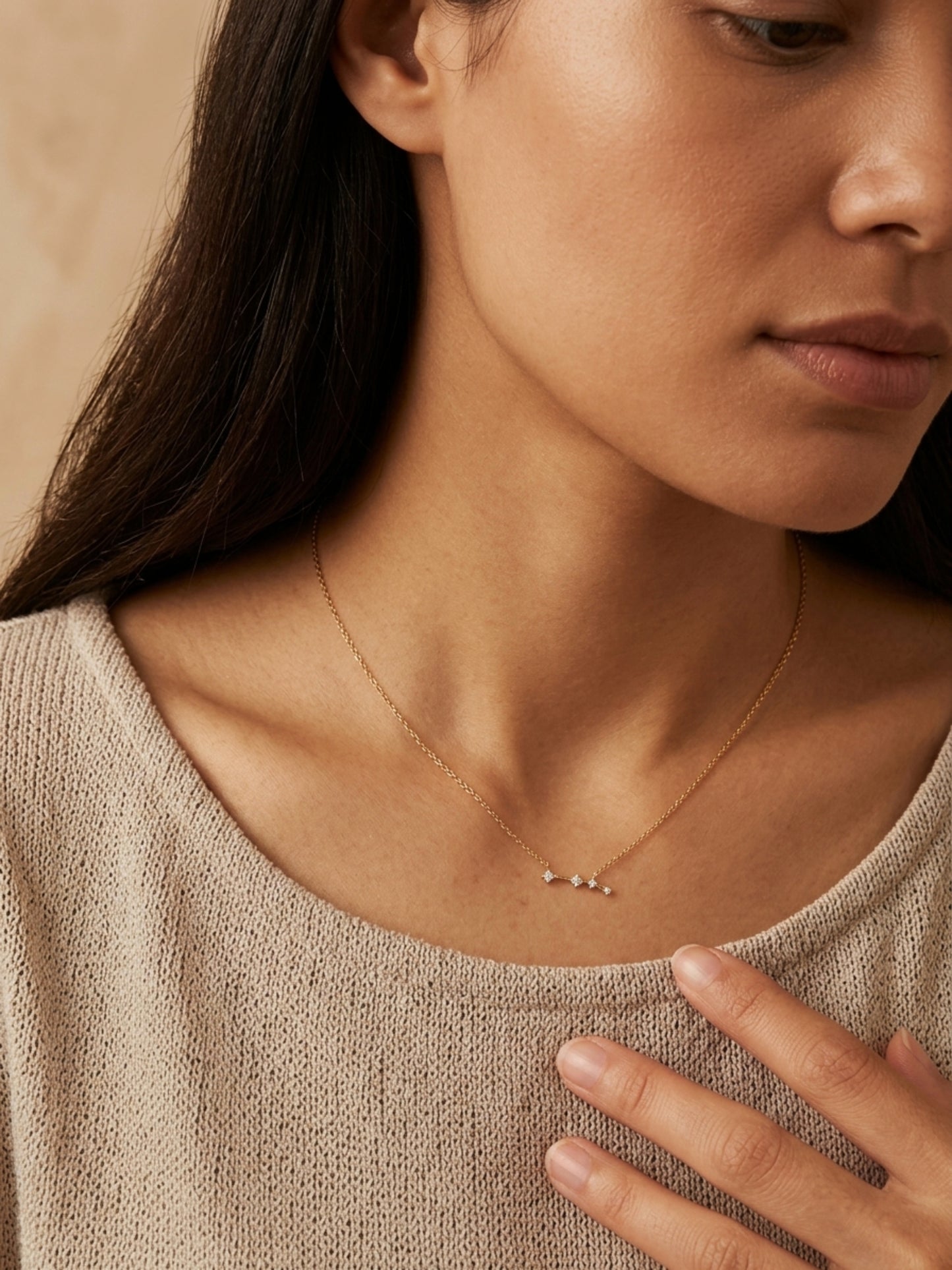 Close-up of a woman wearing an Aries necklace showcasing the luxury aesthetic and pendant scale. Crafted in gold vermeil, a perfect jewellery gift for her.