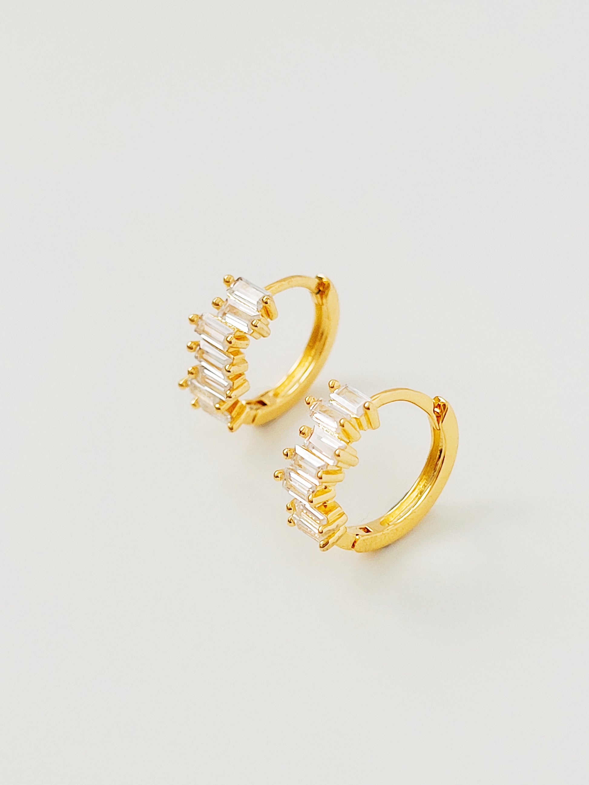 Close-up of Huggie Hoops feature stacked baguette shaped zircons for a cool and stylish look.