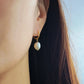 Elegant freshwater pearl drop earring styled on the ear, highlighting its lightweight and comfortable fit.