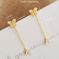 A pair of dainty 18k gold vermeil butterfly stud earring with a delicate chain drop and sparkling pear-cut cubic zirconia stone on a white surface with dimensions.