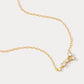 A dainty gold necklace with a pendant featuring a stylized Cancer zodiac constellation sign with sparkling zircons.
