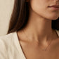Close-up of a woman wearing a Cancer necklace, showcasing the luxury aesthetic and pendant scale.