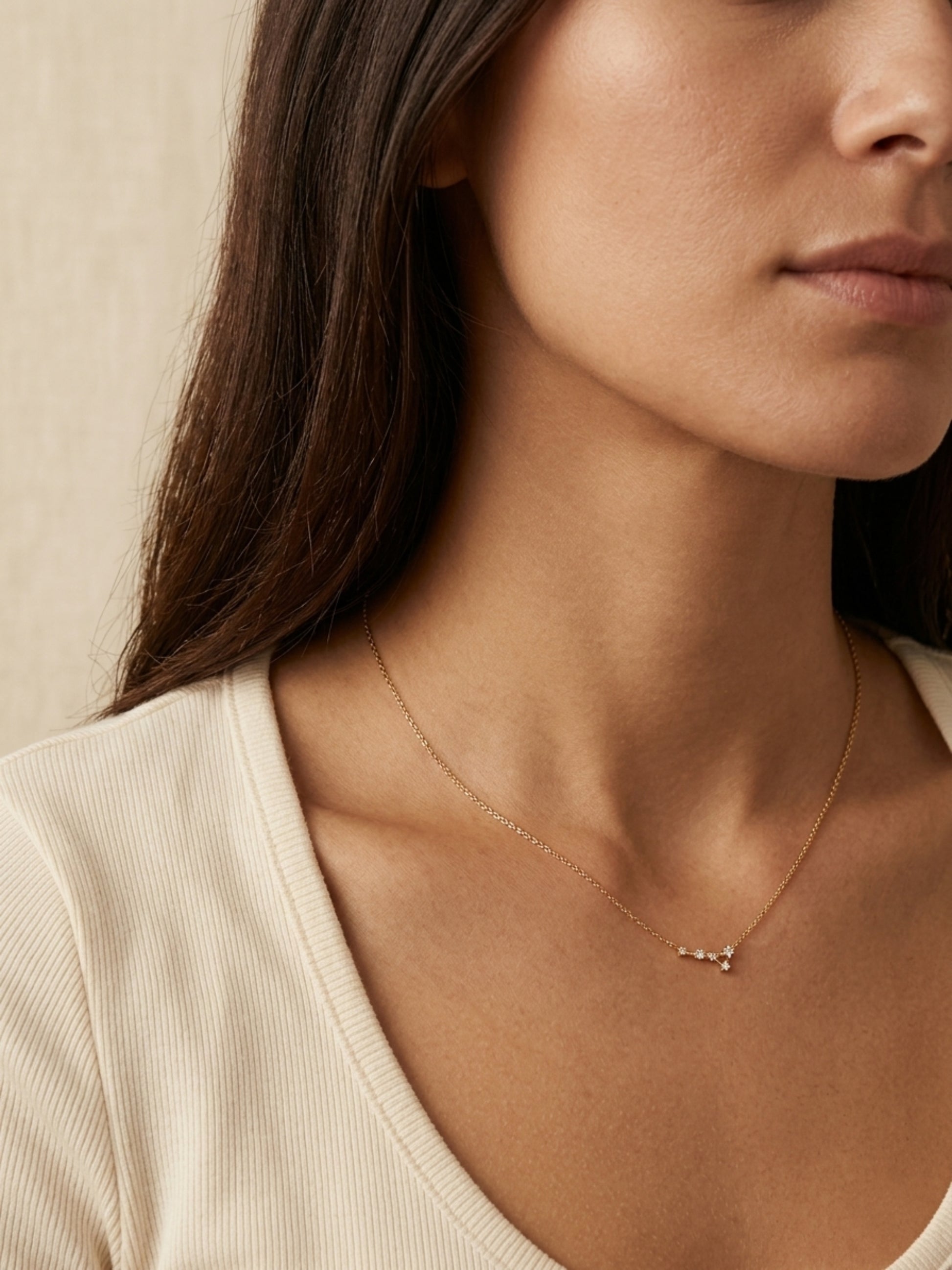 Close-up of a woman wearing a Cancer necklace, showcasing the luxury aesthetic and pendant scale.