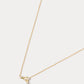 A dainty gold necklace with a pendant featuring a stylized Capricorn zodiac constellation sign with sparkling zircons.