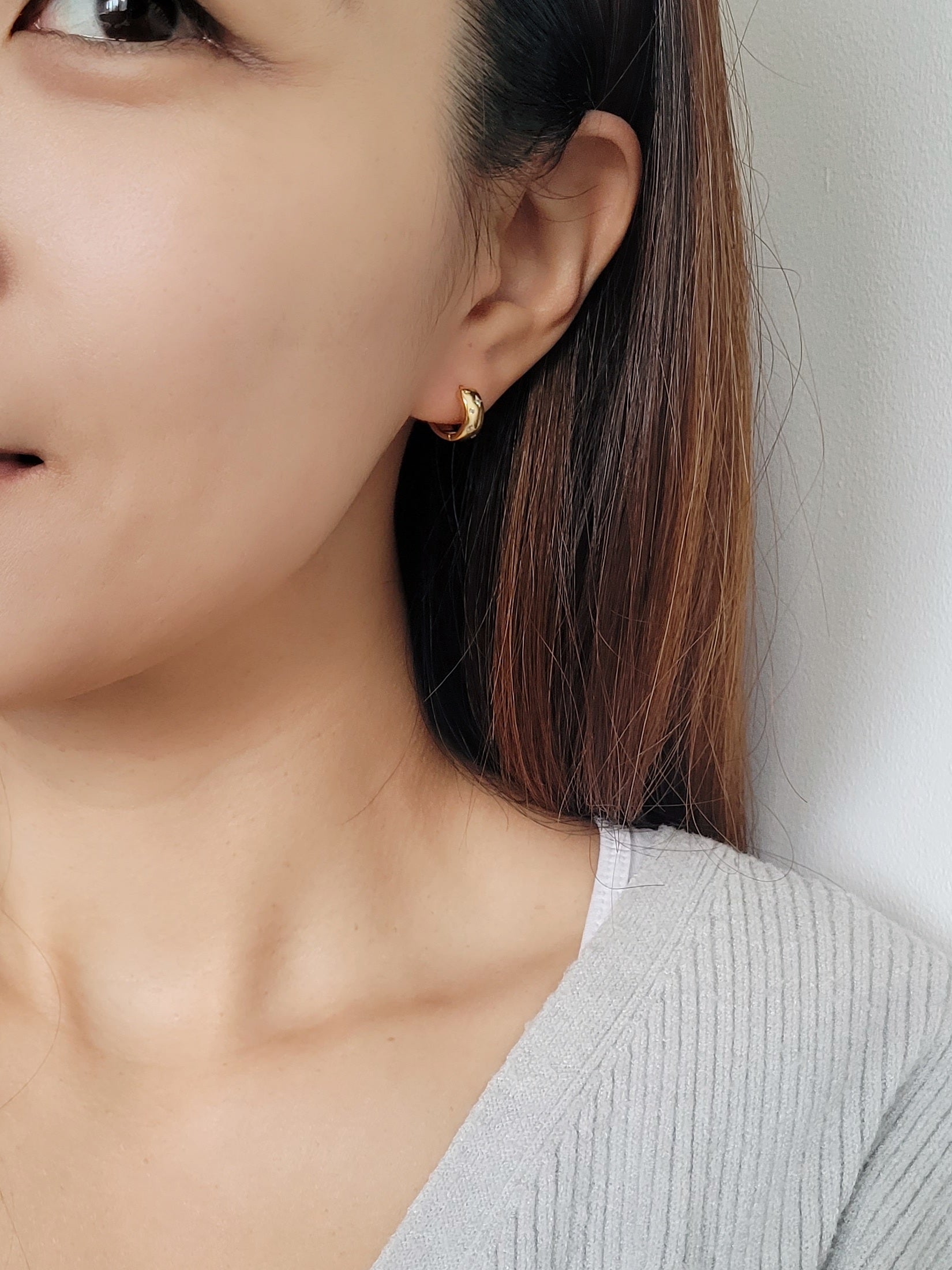 Dainty gold hoop earrings featuring a celestial star motif, crafted in 925 sterling silver and 18K gold vermeil.