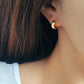 Dainty gold hoop earrings featuring a celestial star motif, crafted in 925 sterling silver and 18K gold vermeil.