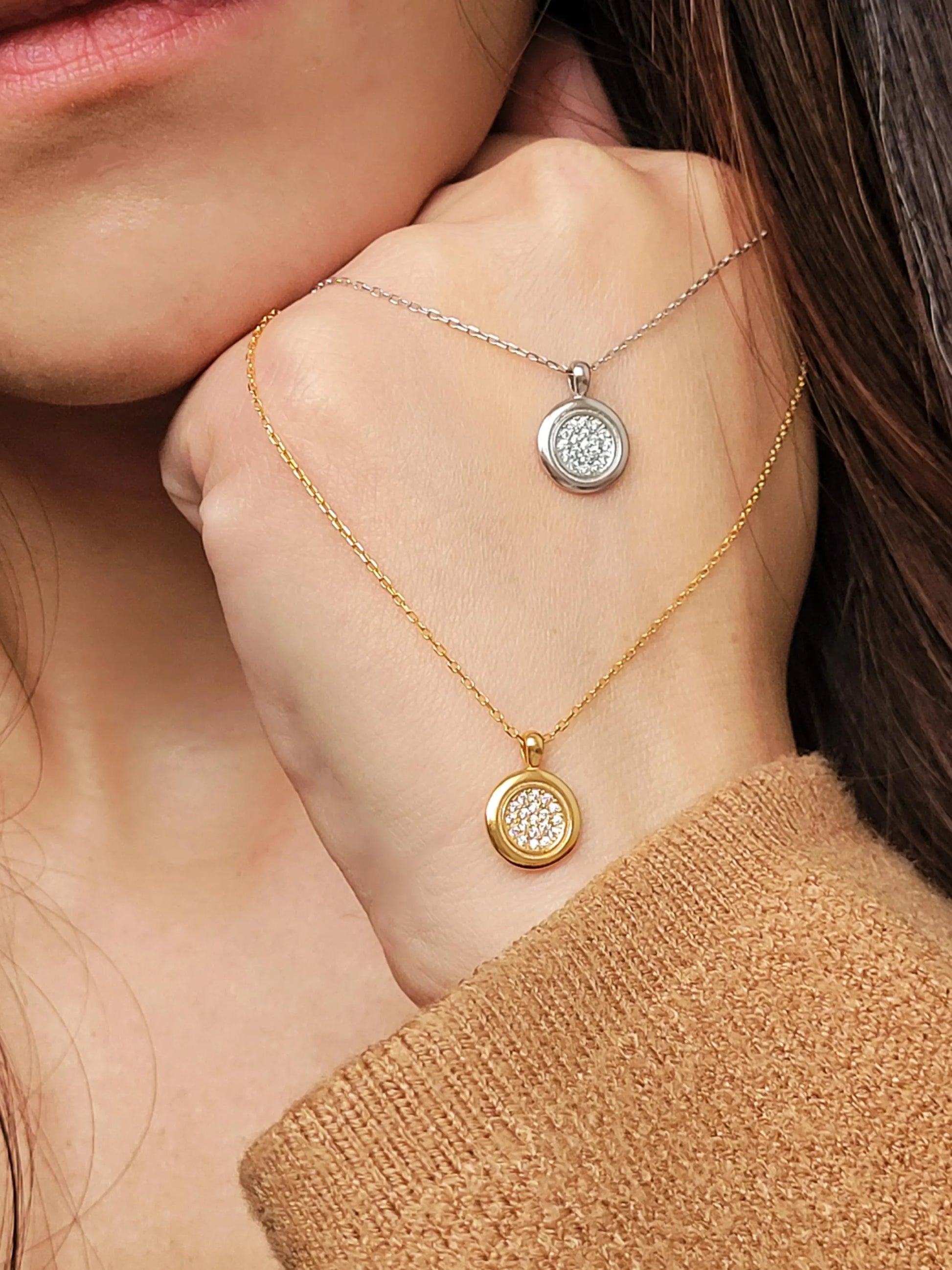 Elegant woman wearing a dainty 18K gold plated sterling silver circle pendant necklace with shimmering cubic zirconia accents, perfect for everyday wear and special occasions.