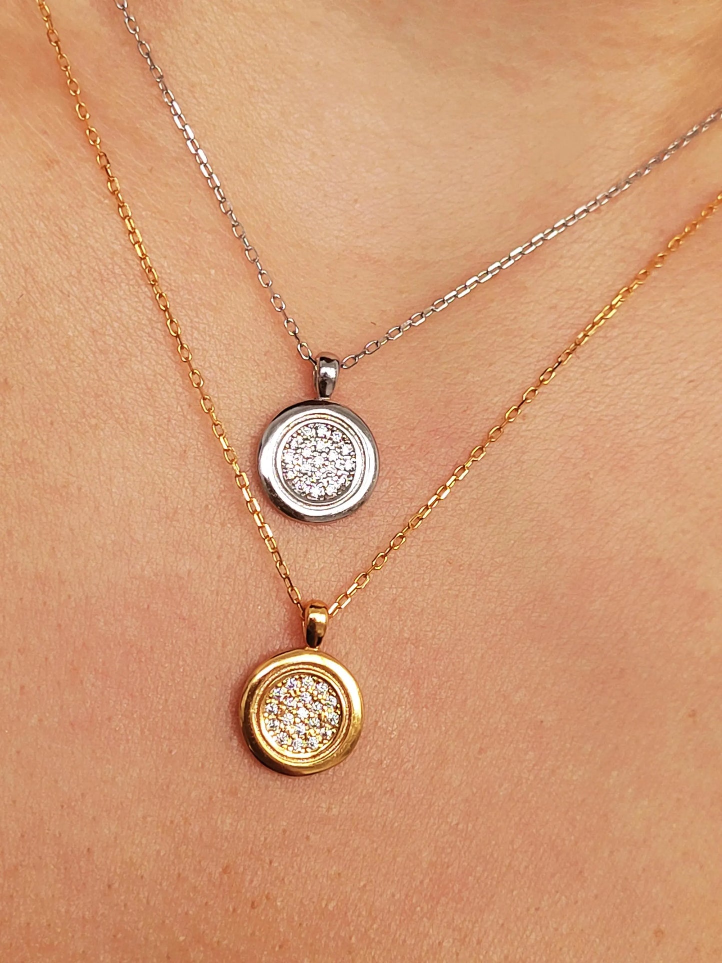 Elegant woman wearing a dainty 18K gold plated sterling silver circle pendant necklace with shimmering cubic zirconia accents, perfect for everyday wear and special occasions.