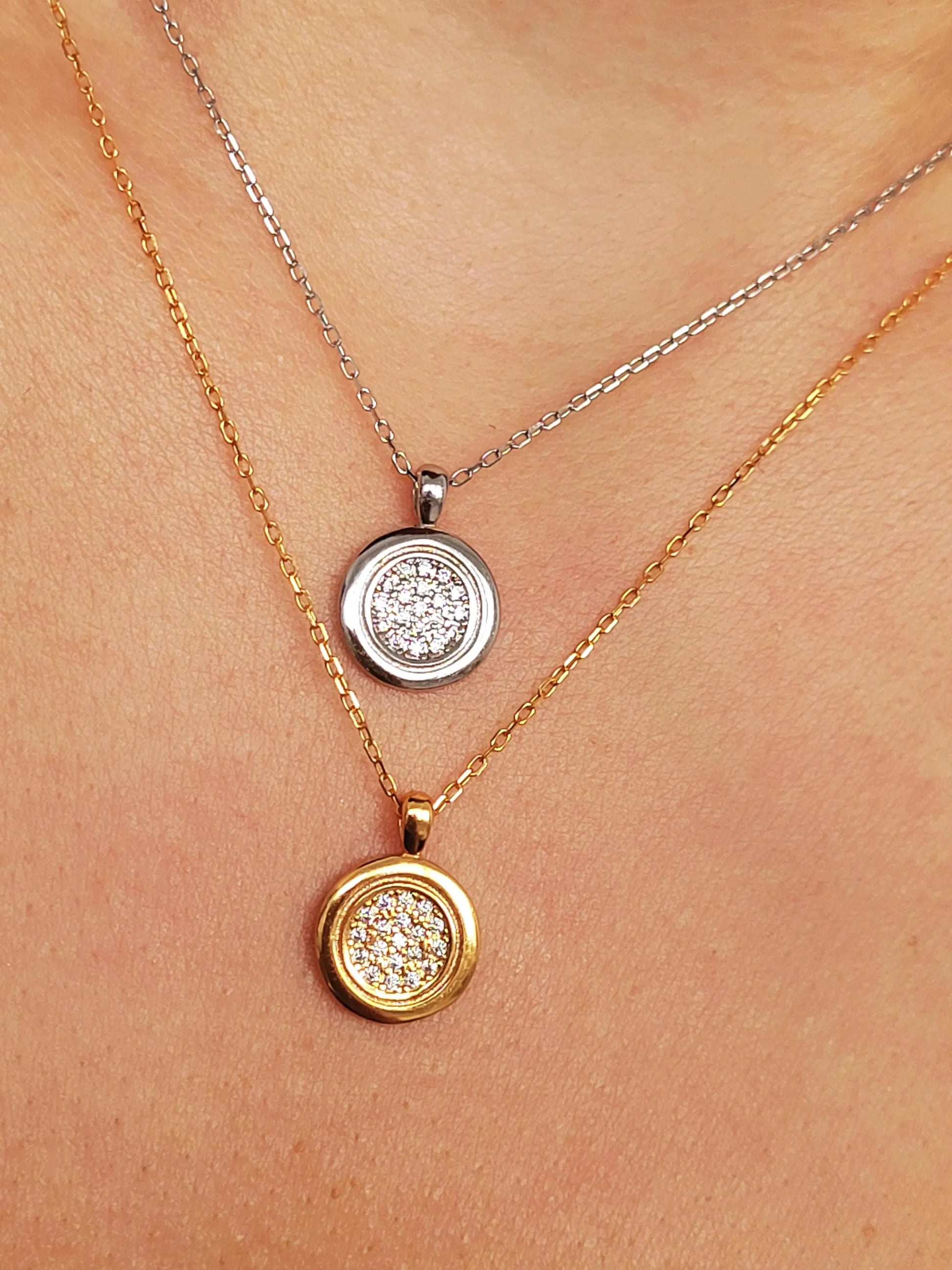 Elegant woman wearing a dainty 18K gold plated sterling silver circle pendant necklace with shimmering cubic zirconia accents, perfect for everyday wear and special occasions.