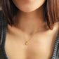 Elegant woman wearing a dainty 18K gold plated sterling silver circle pendant necklace with shimmering cubic zirconia accents, perfect for everyday wear and special occasions.