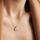Elegant woman wearing a dainty sterling silver circle pendant necklace with shimmering cubic zirconia accents, perfect for everyday wear and special occasions.