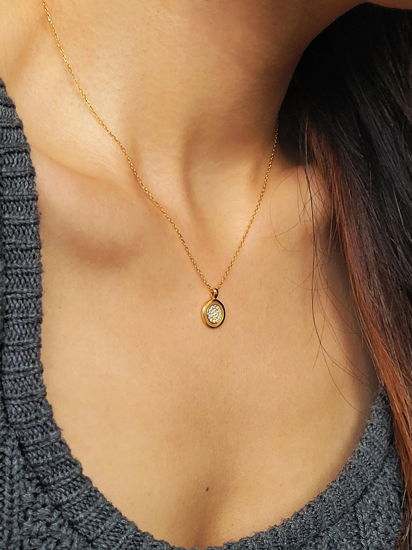 Elegant woman wearing a dainty 18K gold plated sterling silver circle pendant necklace with shimmering cubic zirconia accents, perfect for everyday wear and special occasions.