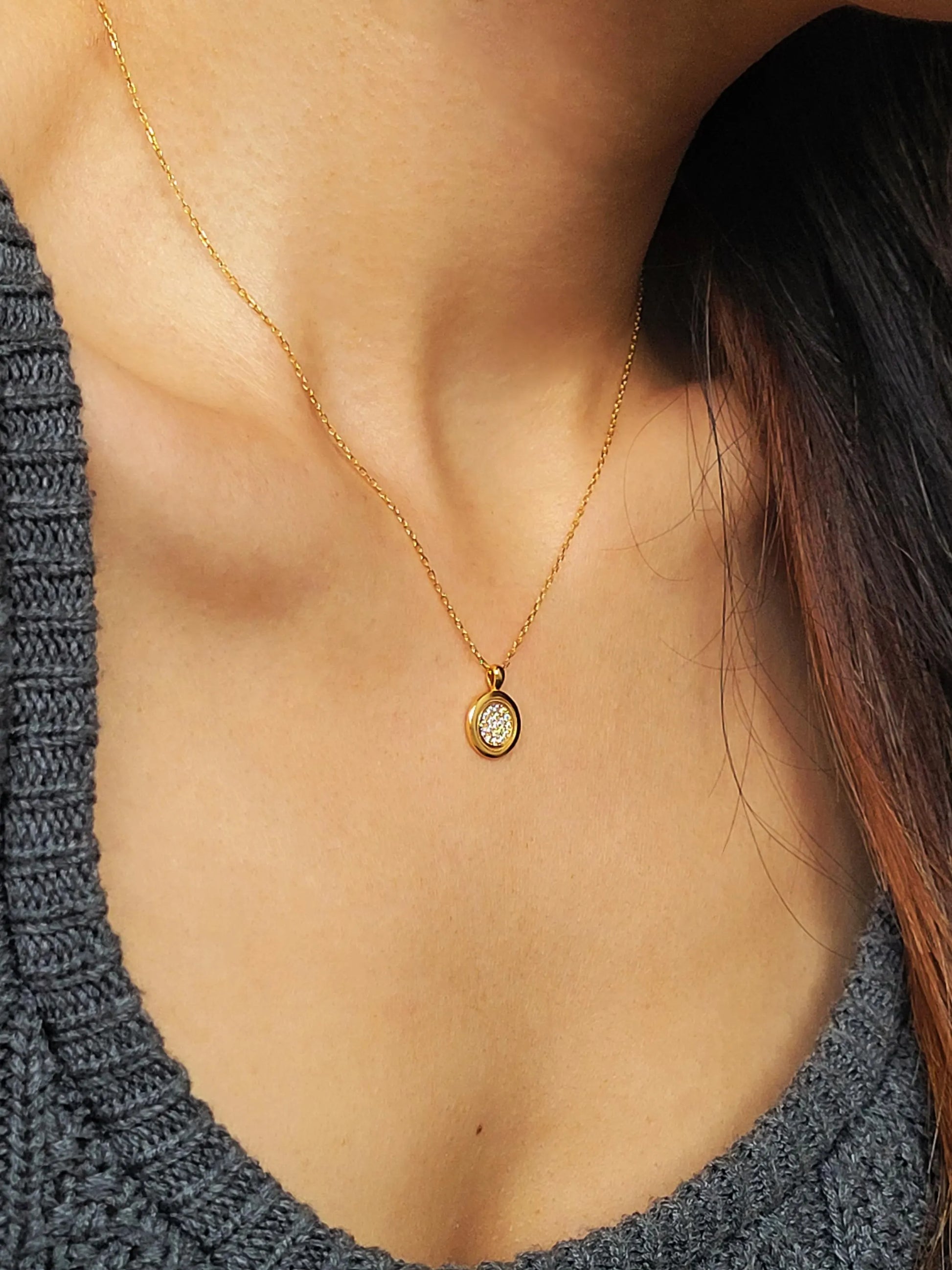 Elegant woman wearing a dainty 18K gold plated sterling silver circle pendant necklace with shimmering cubic zirconia accents, perfect for everyday wear and special occasions.