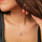 Elegant woman wearing a dainty sterling silver circle pendant necklace with shimmering cubic zirconia accents, perfect for everyday wear and special occasions.