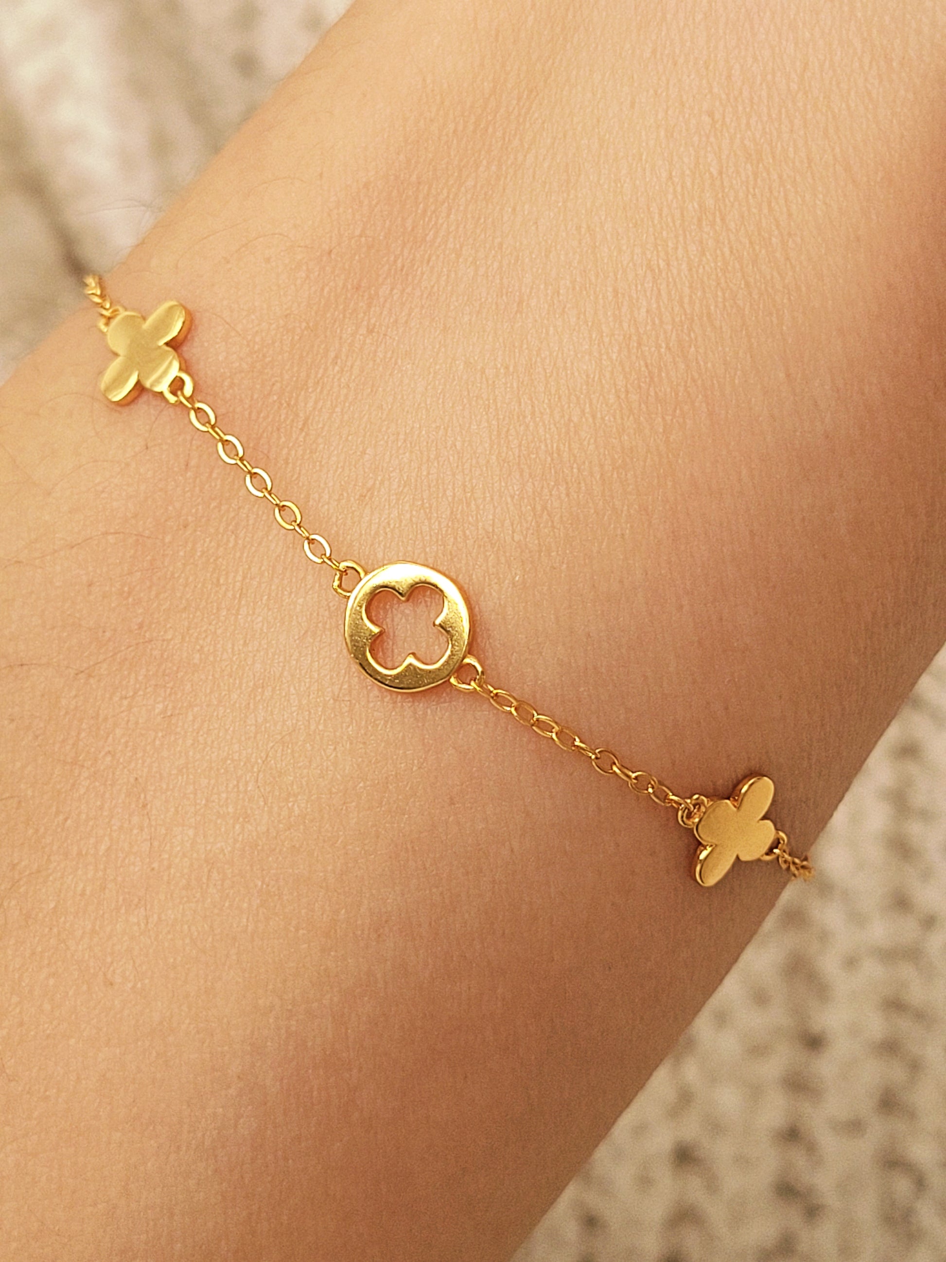 A dainty gold bracelet featuring van cleef clover motif, crafted in gold plated sterling silver.