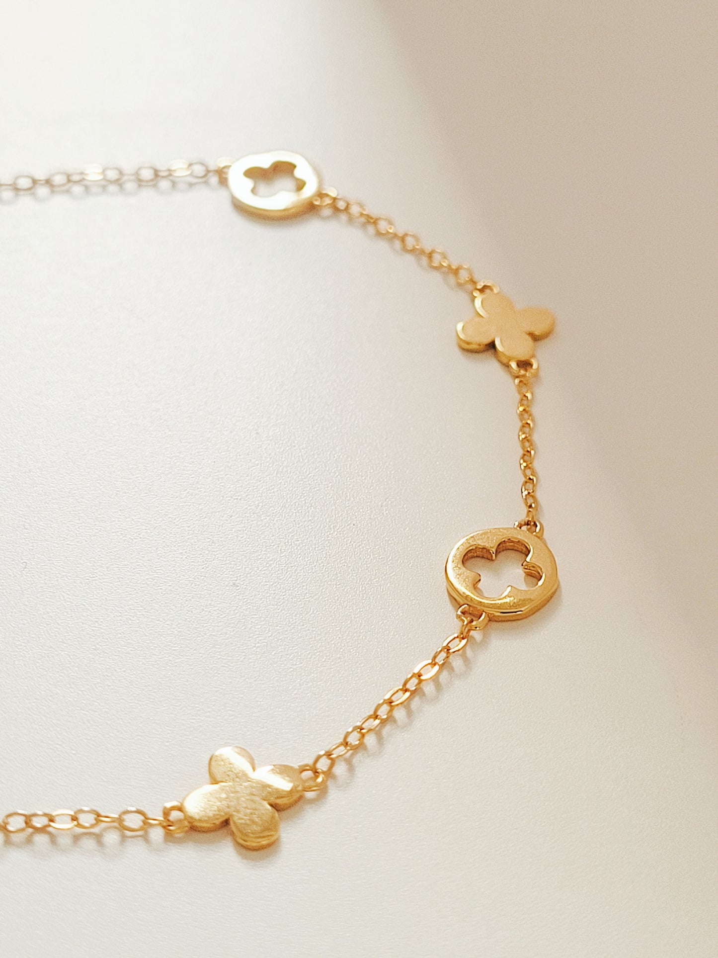 A dainty gold bracelet featuring van cleef clover motif, crafted in gold plated sterling silver.