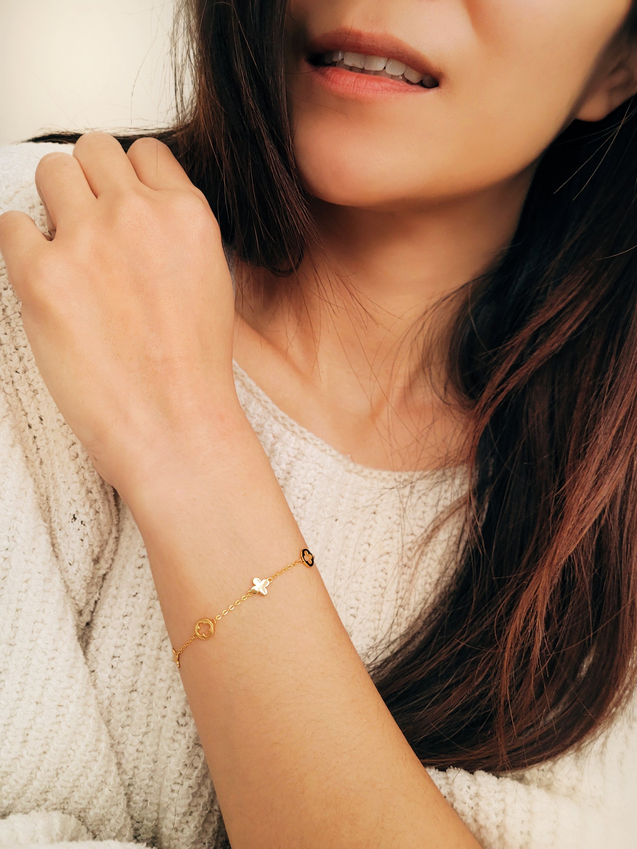 A dainty gold bracelet featuring good luck clover motif, crafted in gold plated sterling silver.