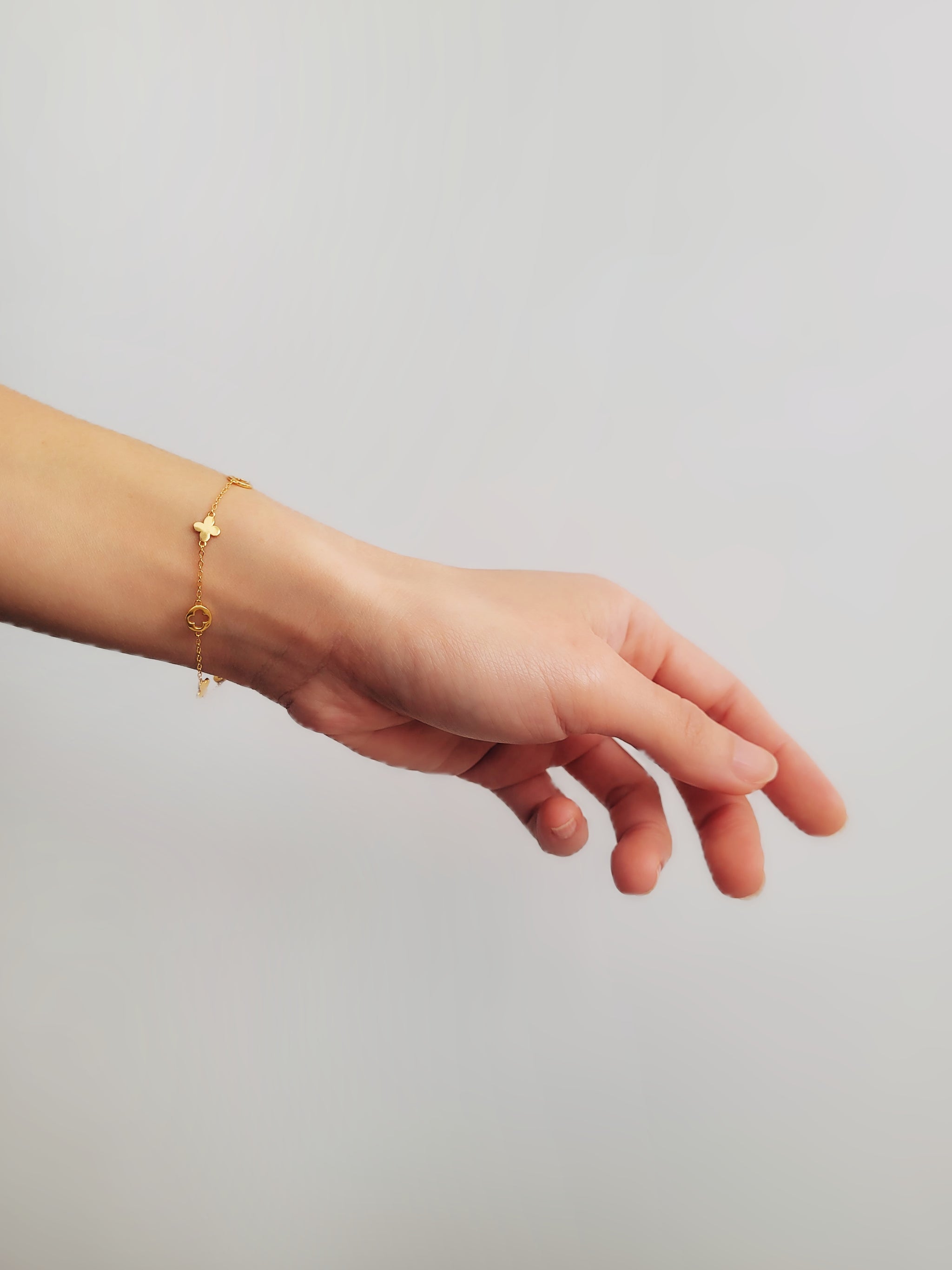 A dainty gold bracelet featuring clover motif, crafted in gold plated sterling silver.