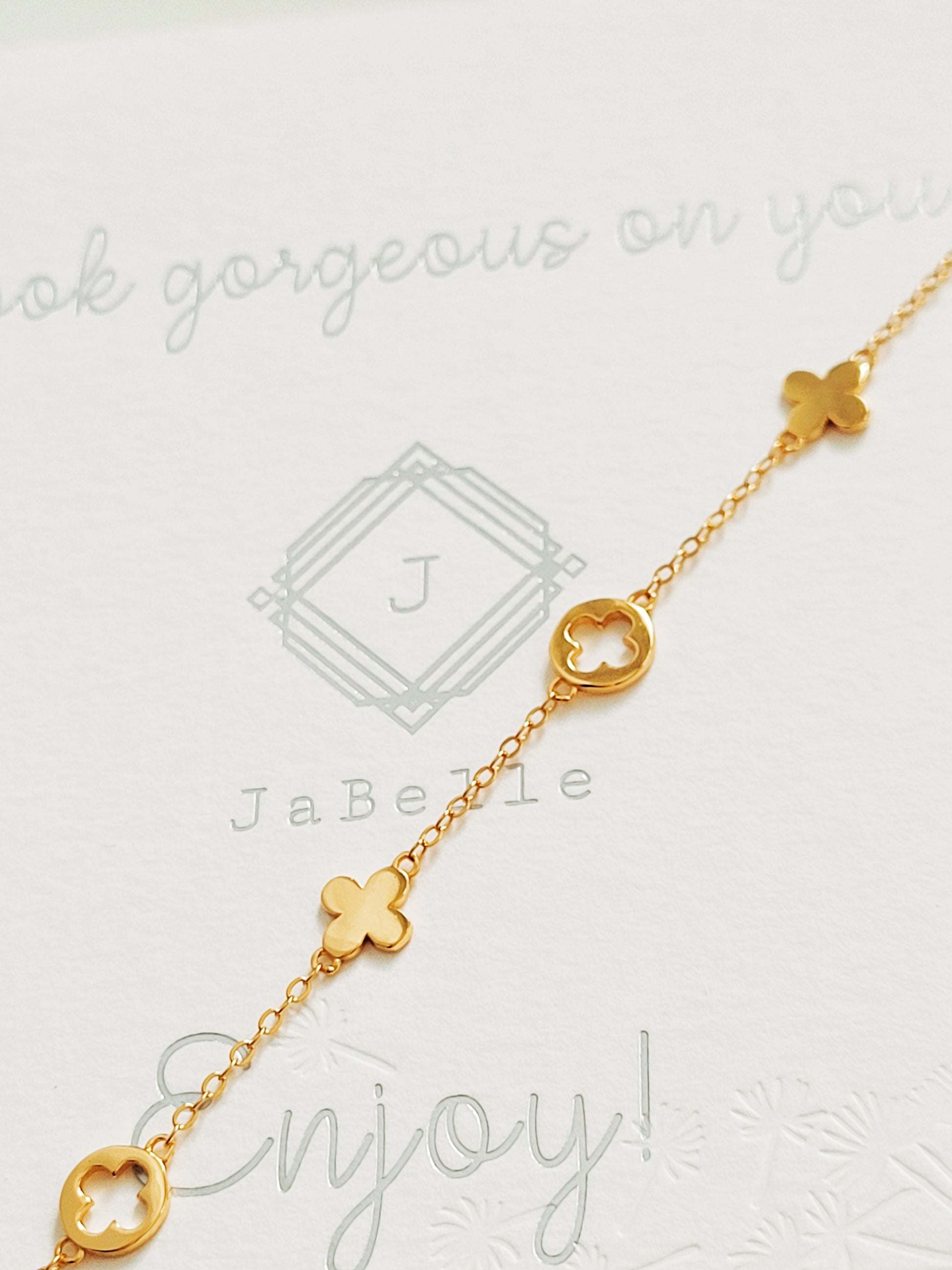 A dainty gold bracelet featuring van cleef clover motif, crafted in gold plated sterling silver.